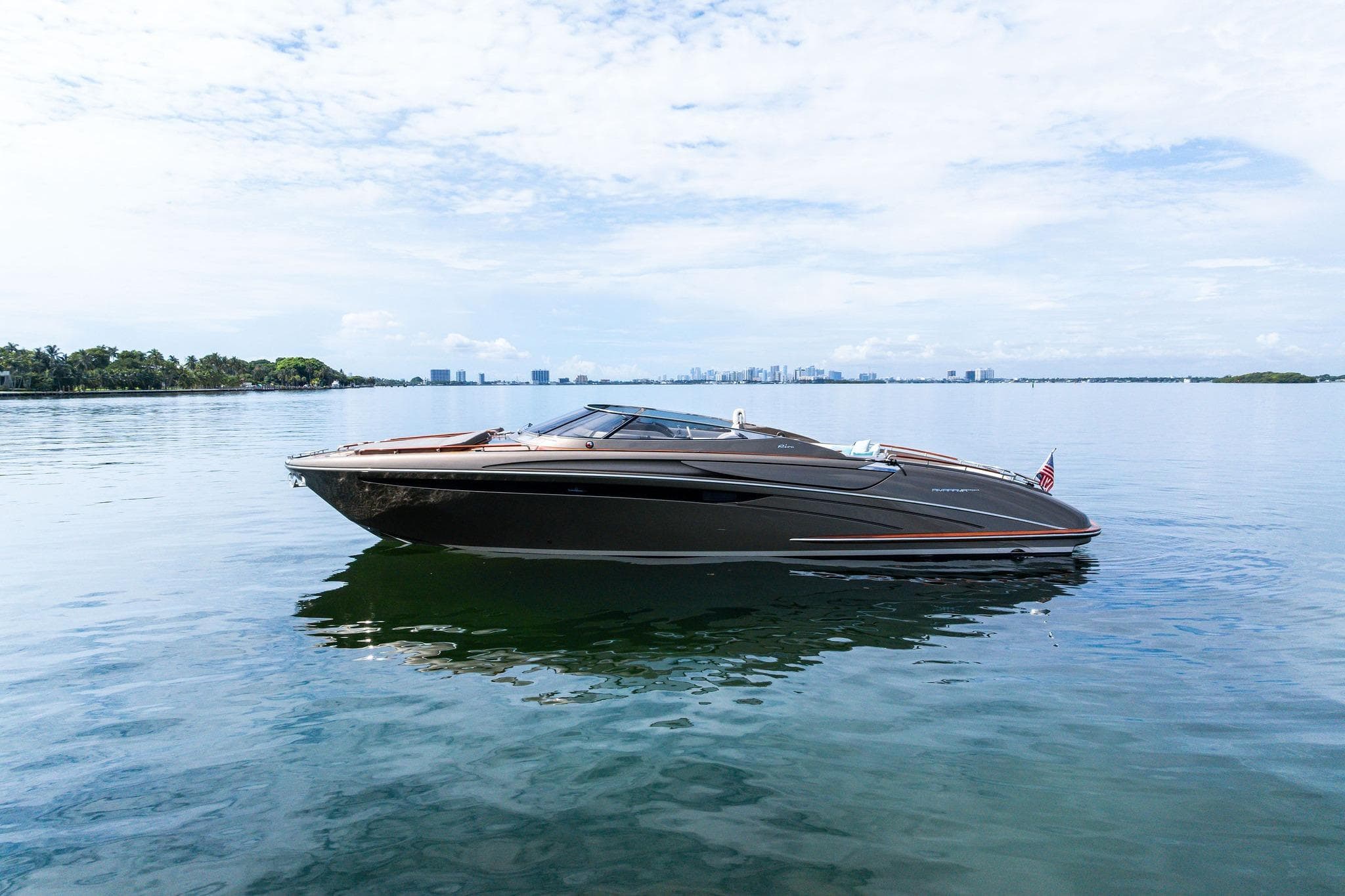2014 Riva Rivarama luxury yacht on calm water under a clear sky.