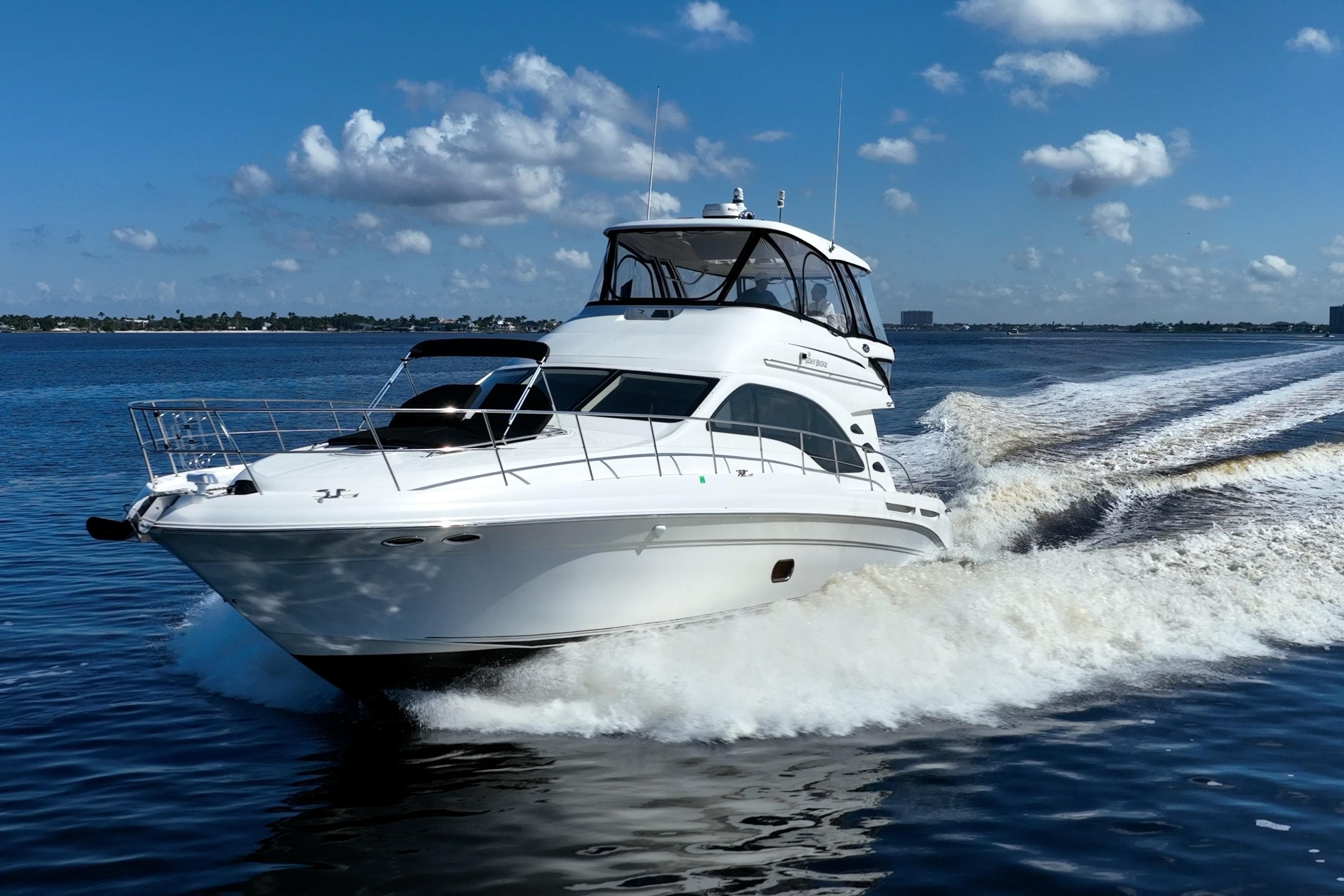2007 Sea Ray 580 Sedan Bridge yacht cruising on open water under a clear sky.