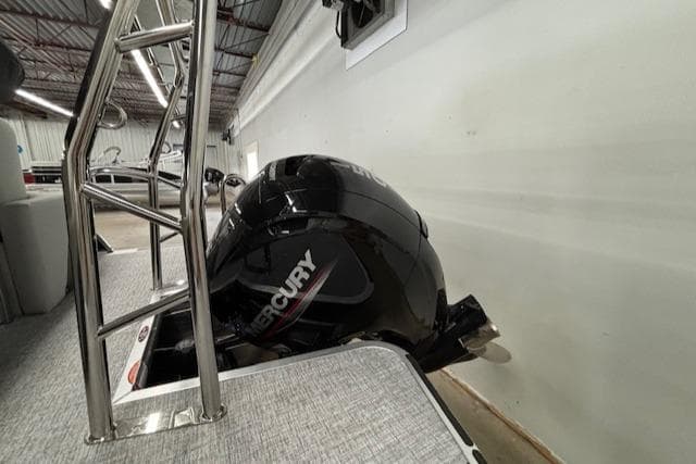 2025 Harris Cruiser 230 CWDH with Mercury outboard engine in showroom.