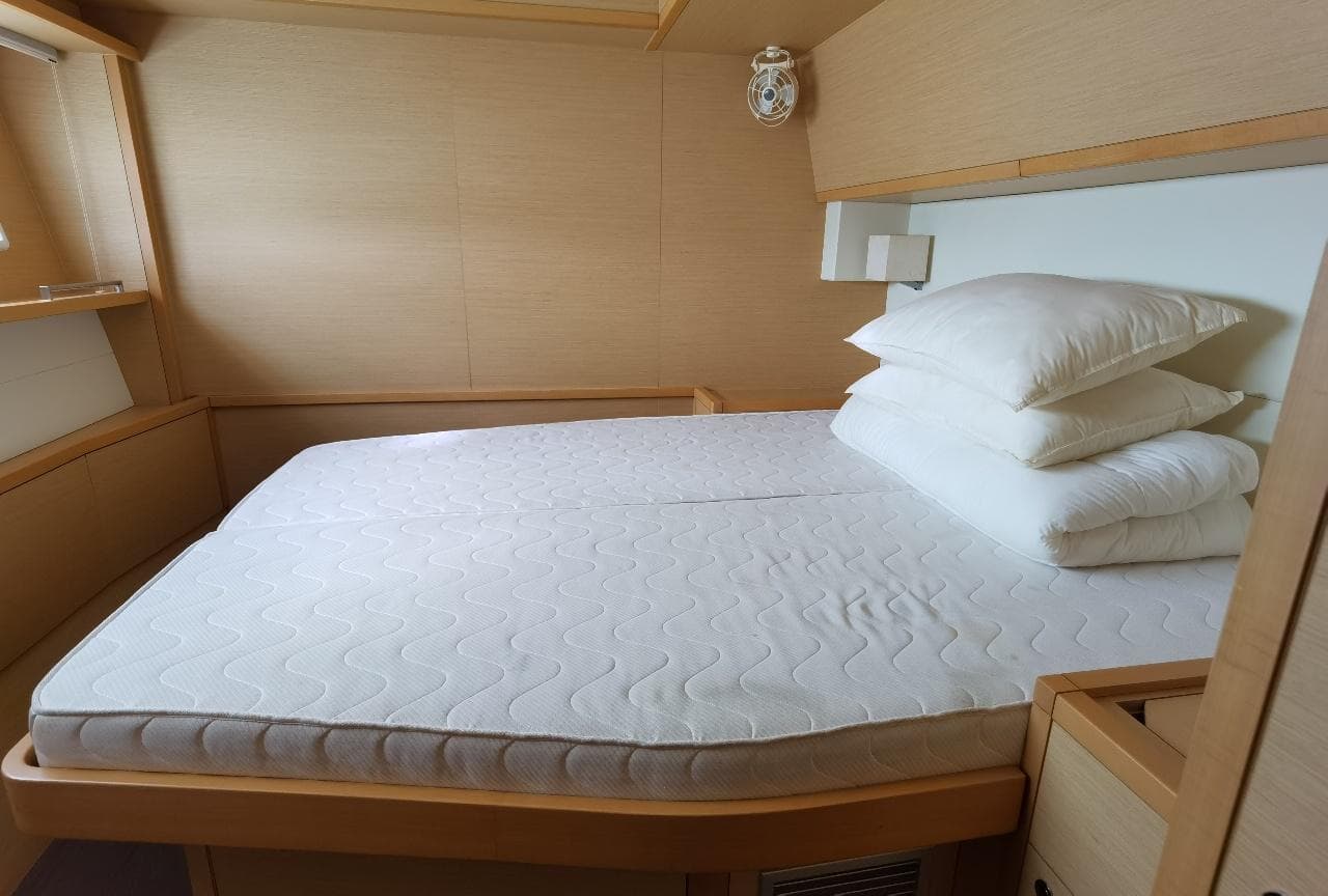 Luxurious cabin interior of 2014 Lagoon 620 yacht with comfortable bedding.