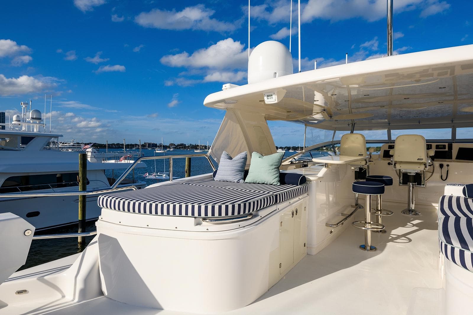 Luxurious 2009 Pacific Mariner 85 yacht deck with seating, under a clear blue sky.