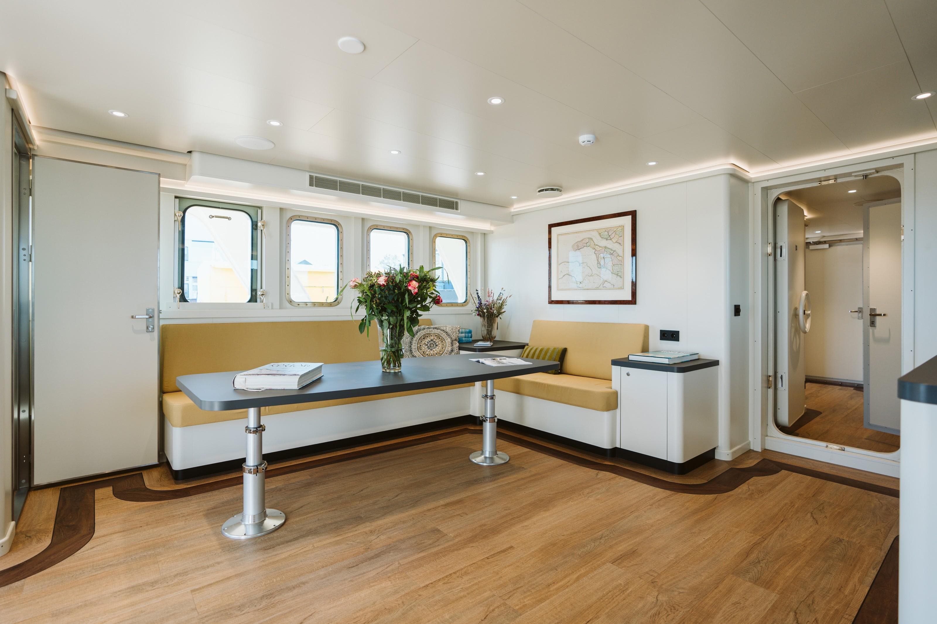 Luxurious yacht interior with seating, table, and decor; Damen Custom, 1988 model.