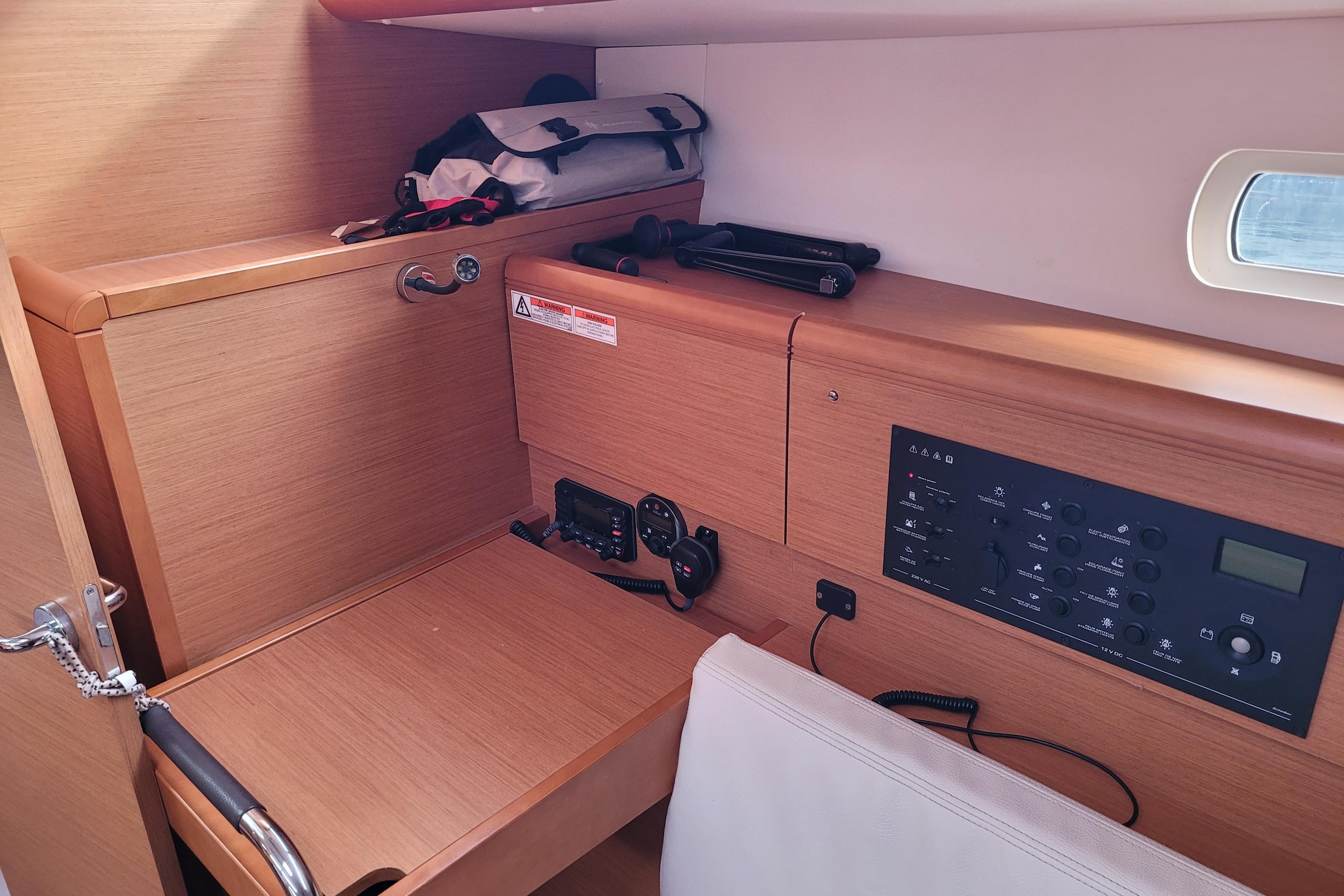 Interior of 2014 Jeanneau 379 sailboat with navigation panel and storage area.