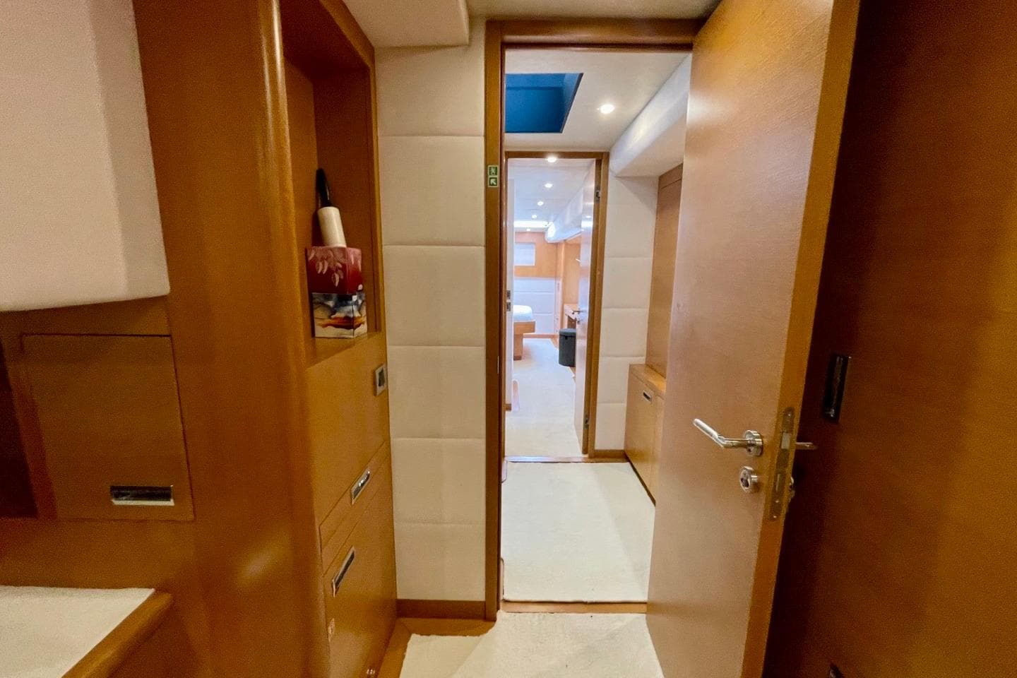Interior view of 2018 Serenity 64 yacht, featuring wooden cabinetry and modern design.