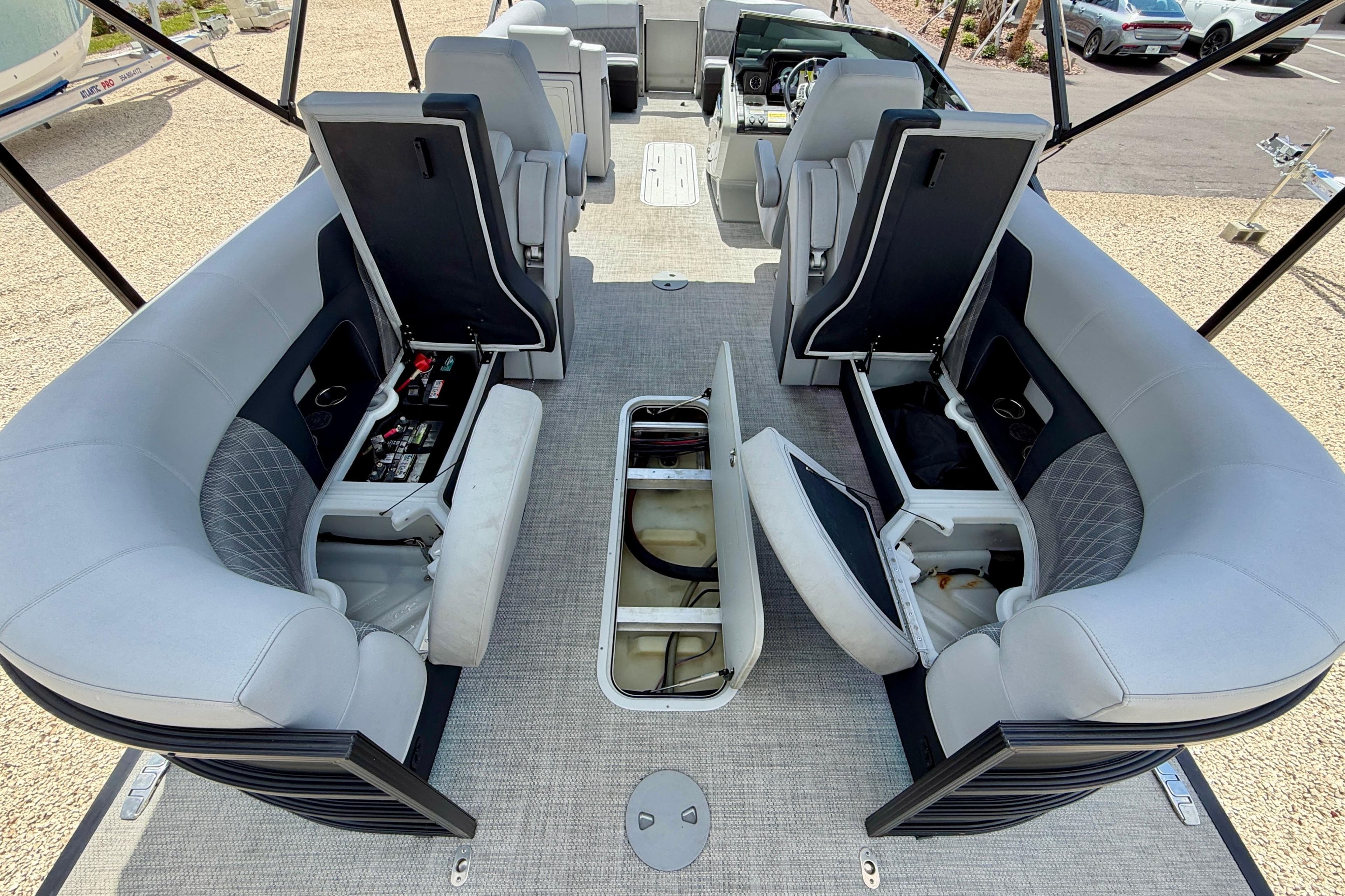 Luxurious interior of 2025 Vanderbilt 700T boat with open storage compartments.