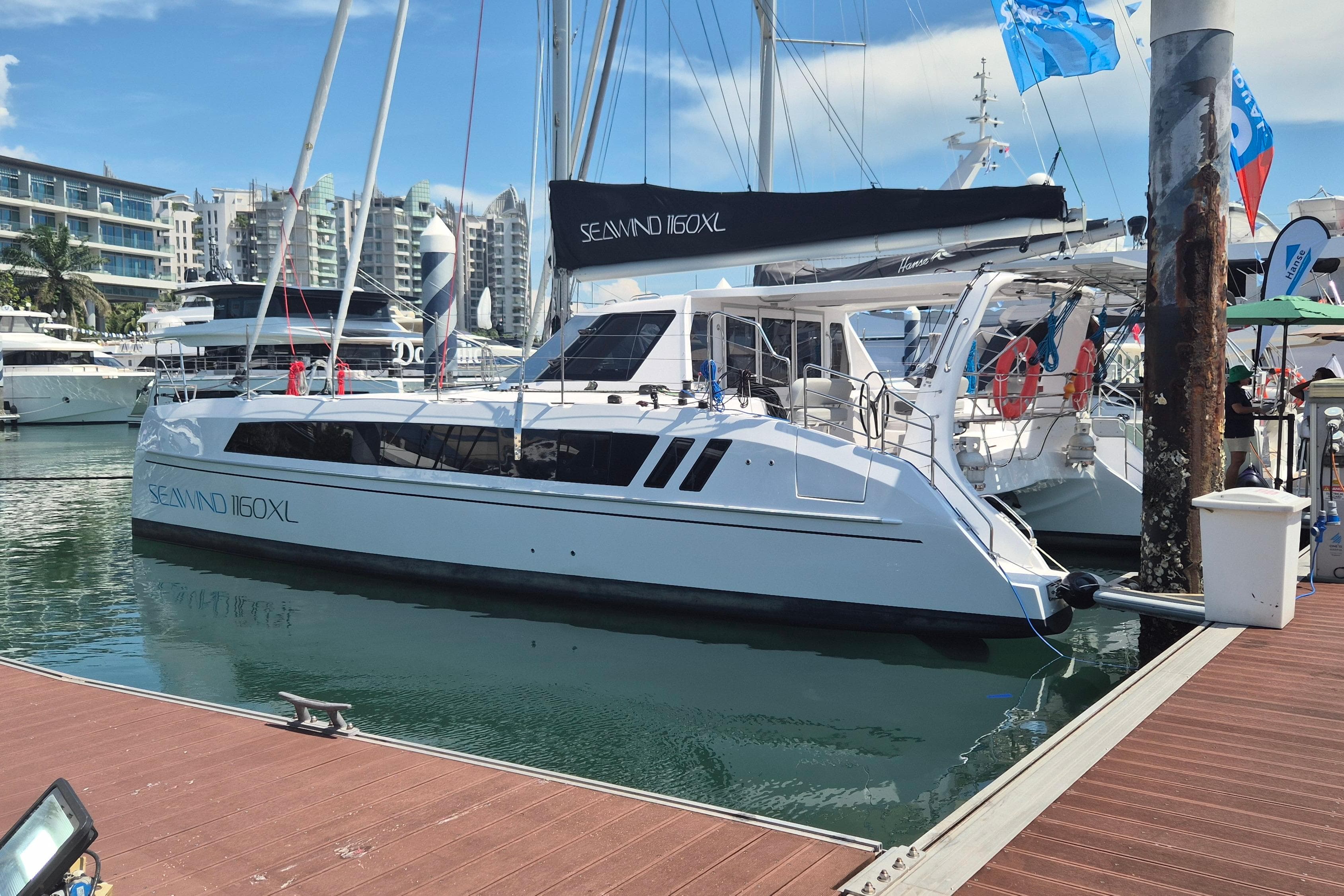2026 Seawind 1160XL catamaran docked at marina, showcasing sleek design and modern features.