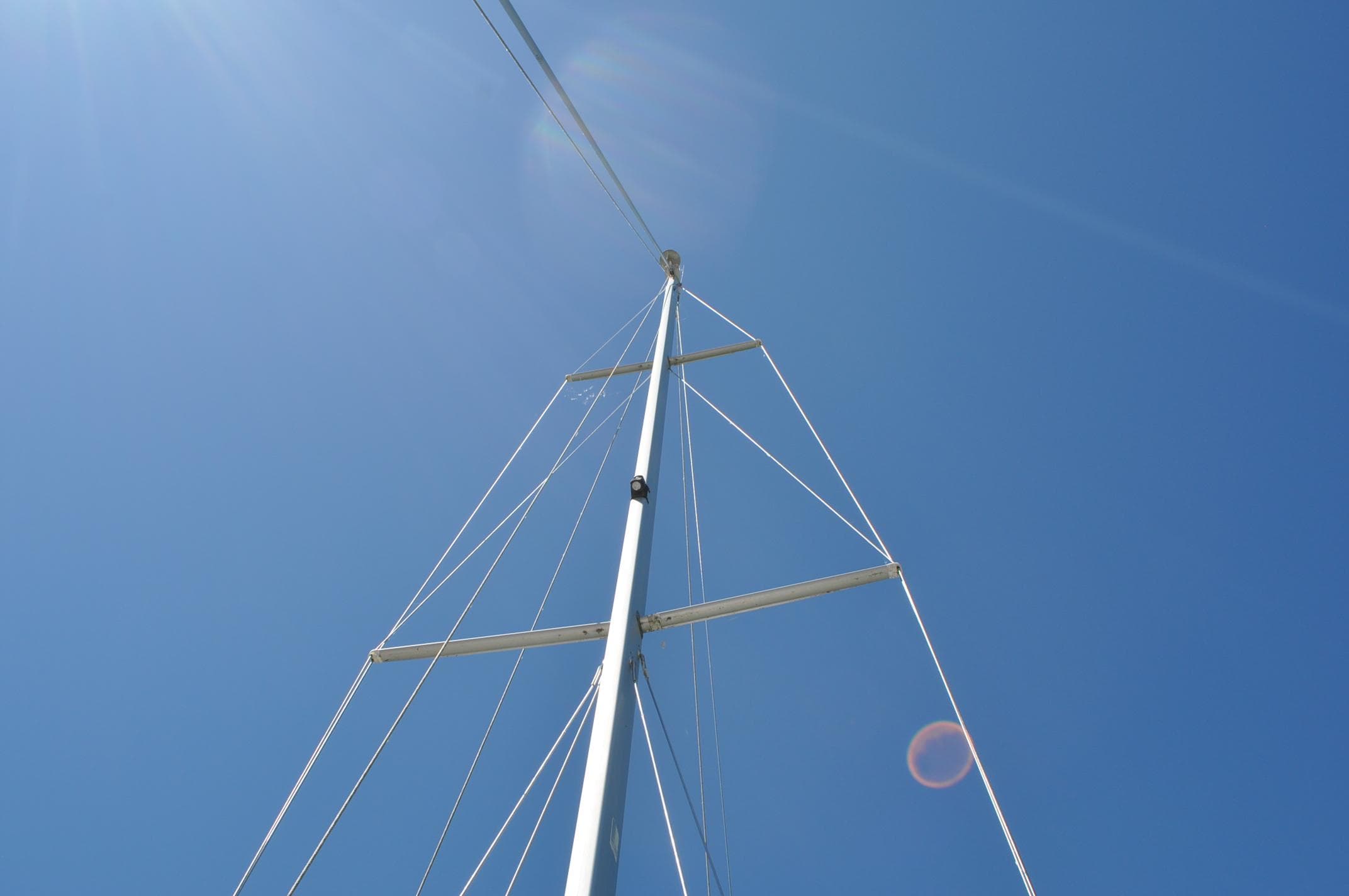 Mast of a 2004 Catalina 350 MkII sailboat against a clear blue sky.