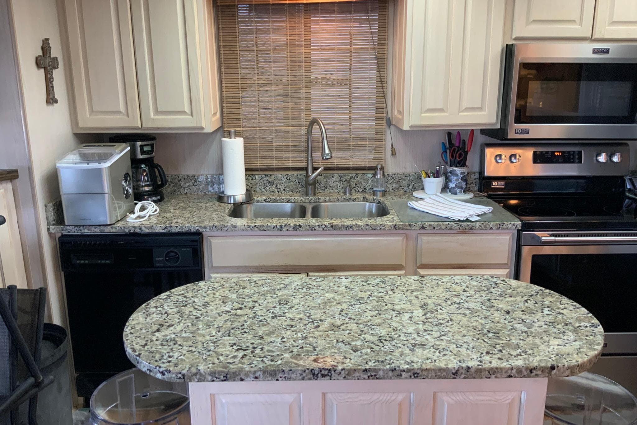 Modern kitchen with granite countertops, stainless steel appliances, and beige cabinets in a 1997 Lakeview model.