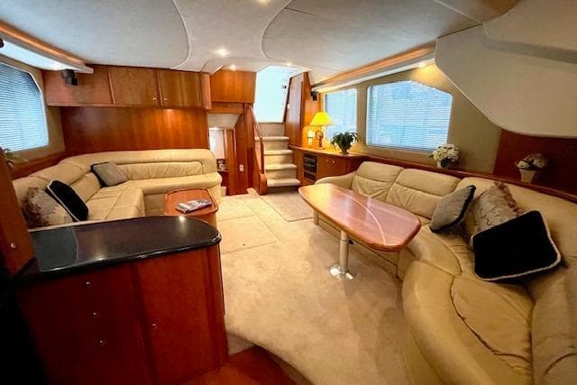 Luxurious interior of a 2002 Silverton 43 Motor Yacht with plush seating and elegant decor.