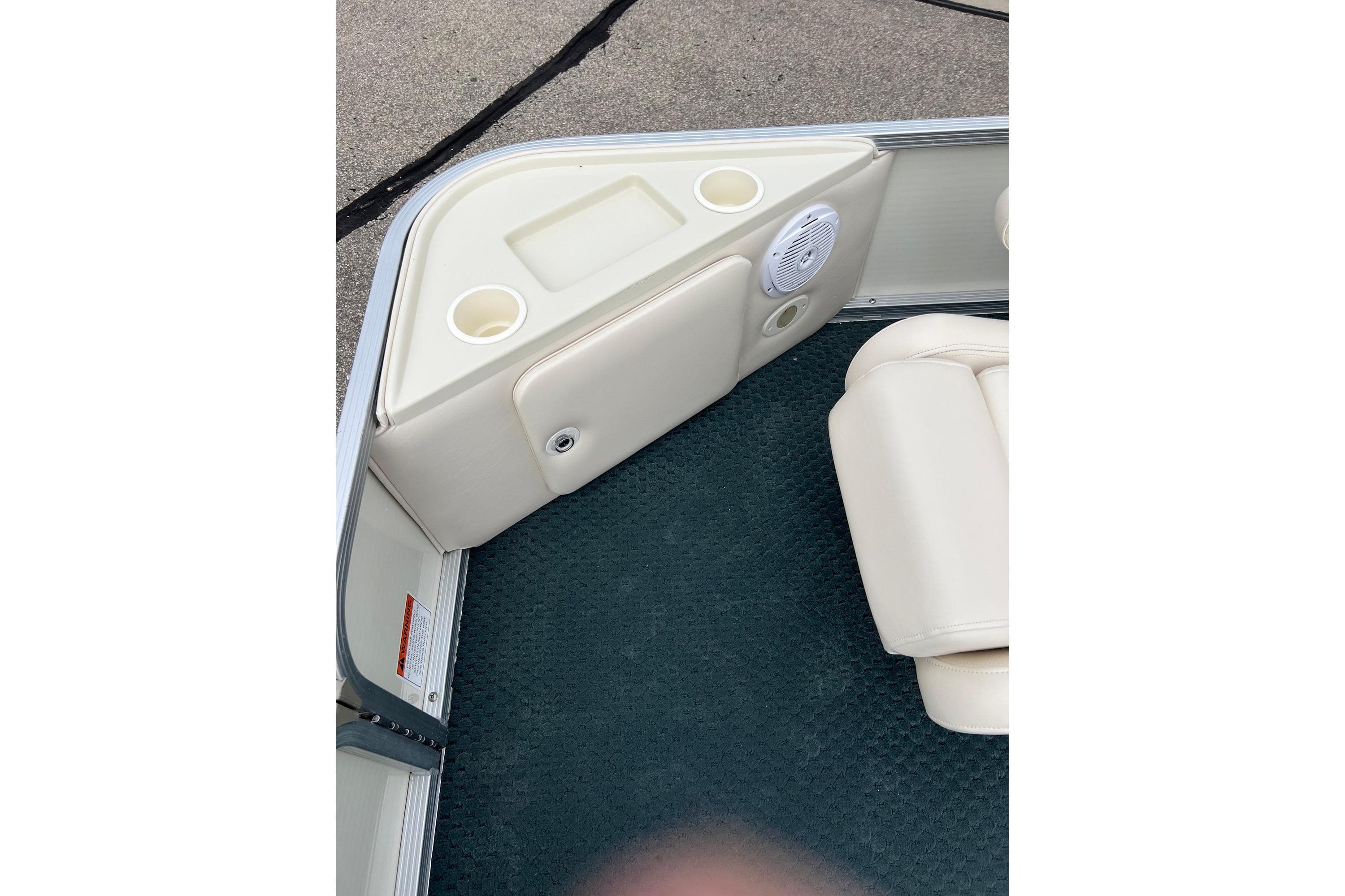 Interior of a 2006 Bennington 2575 FS boat with cup holders and speaker.