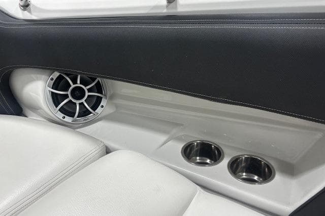 Interior of 2019 Crownline Eclipse E255 SURF boat with speaker and cup holders.