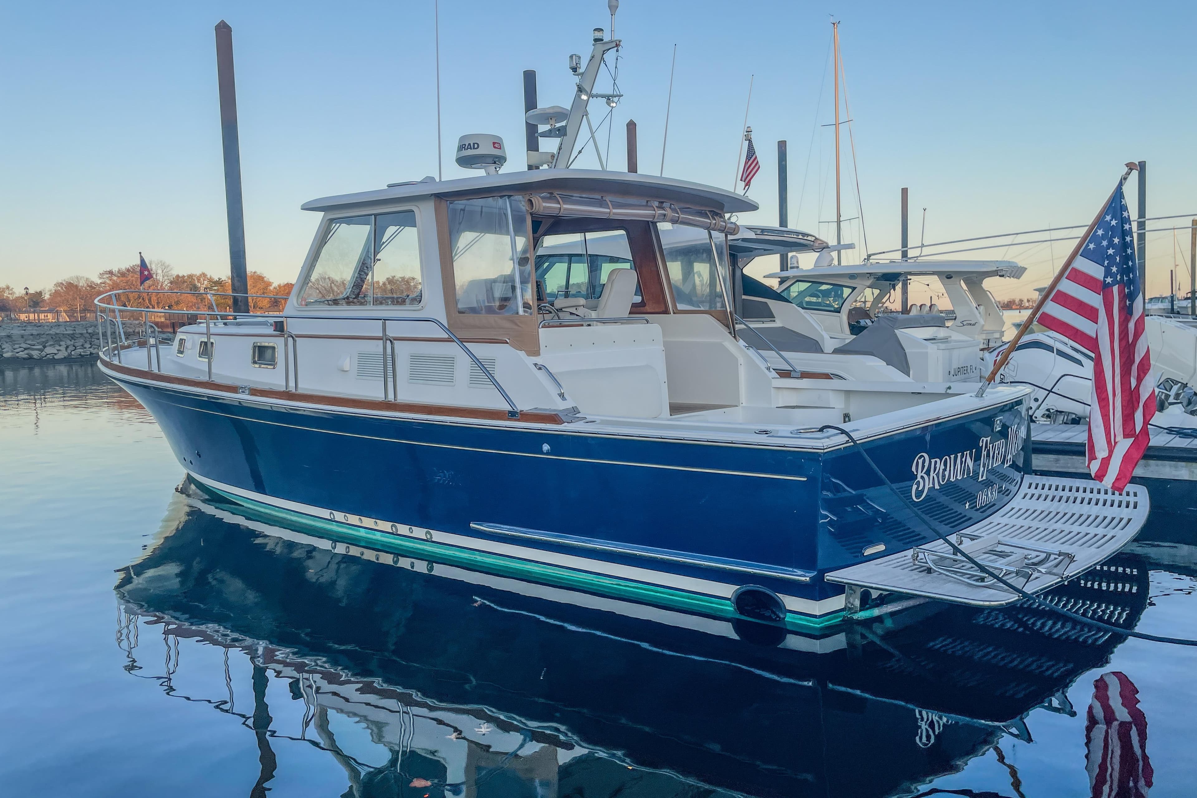 2001 Grand Banks 38 Eastbay HX yacht docked in a serene marina setting.