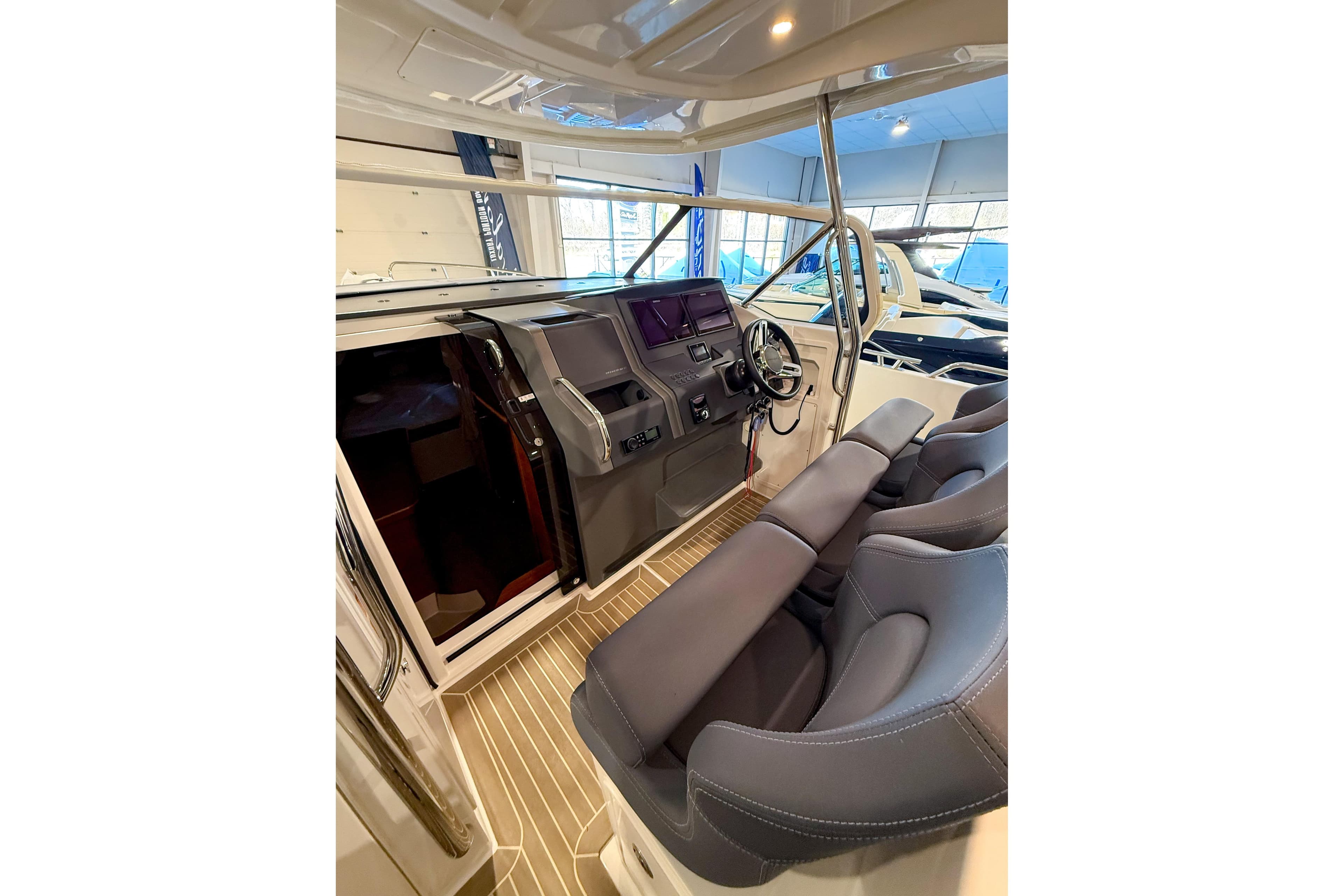 Interior of 2022 Nimbus T11 boat with modern helm and seating.