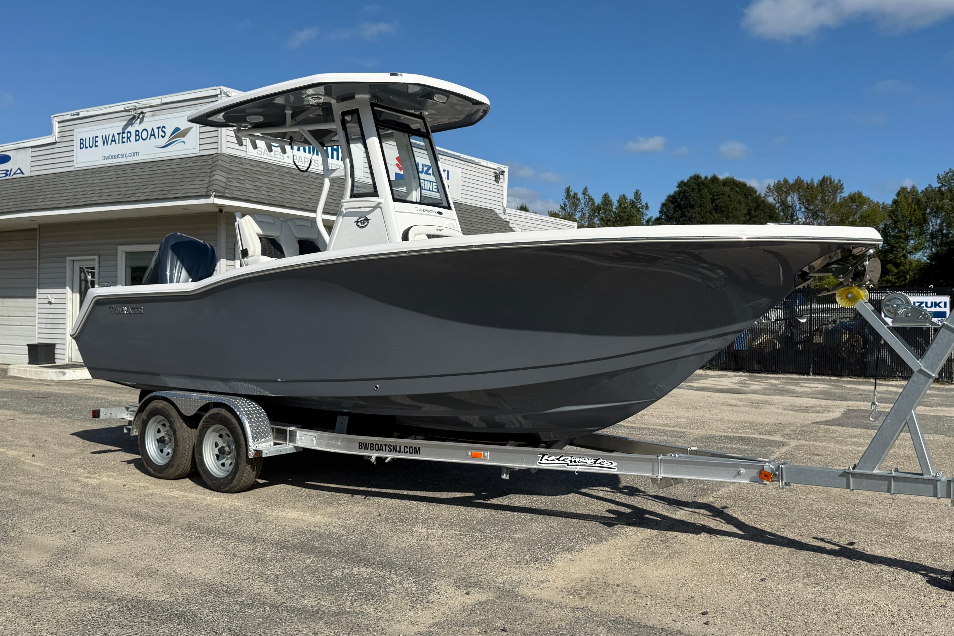 2026 Tidewater 232 CC Adventure boat on trailer at Blue Water Boats dealership.