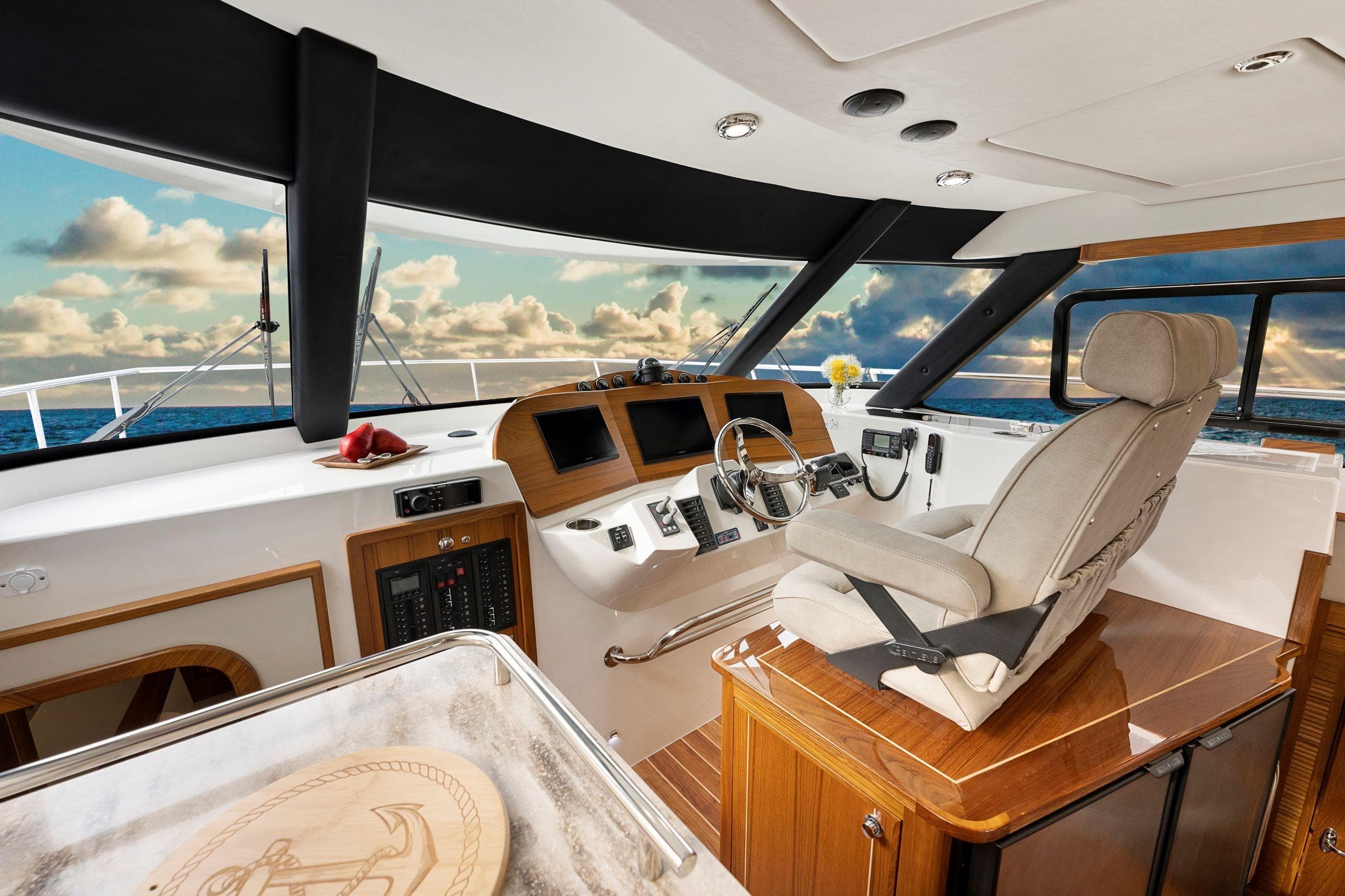 Luxurious interior of 2026 Aspen C120 Flybridge yacht with modern helm and ocean view.