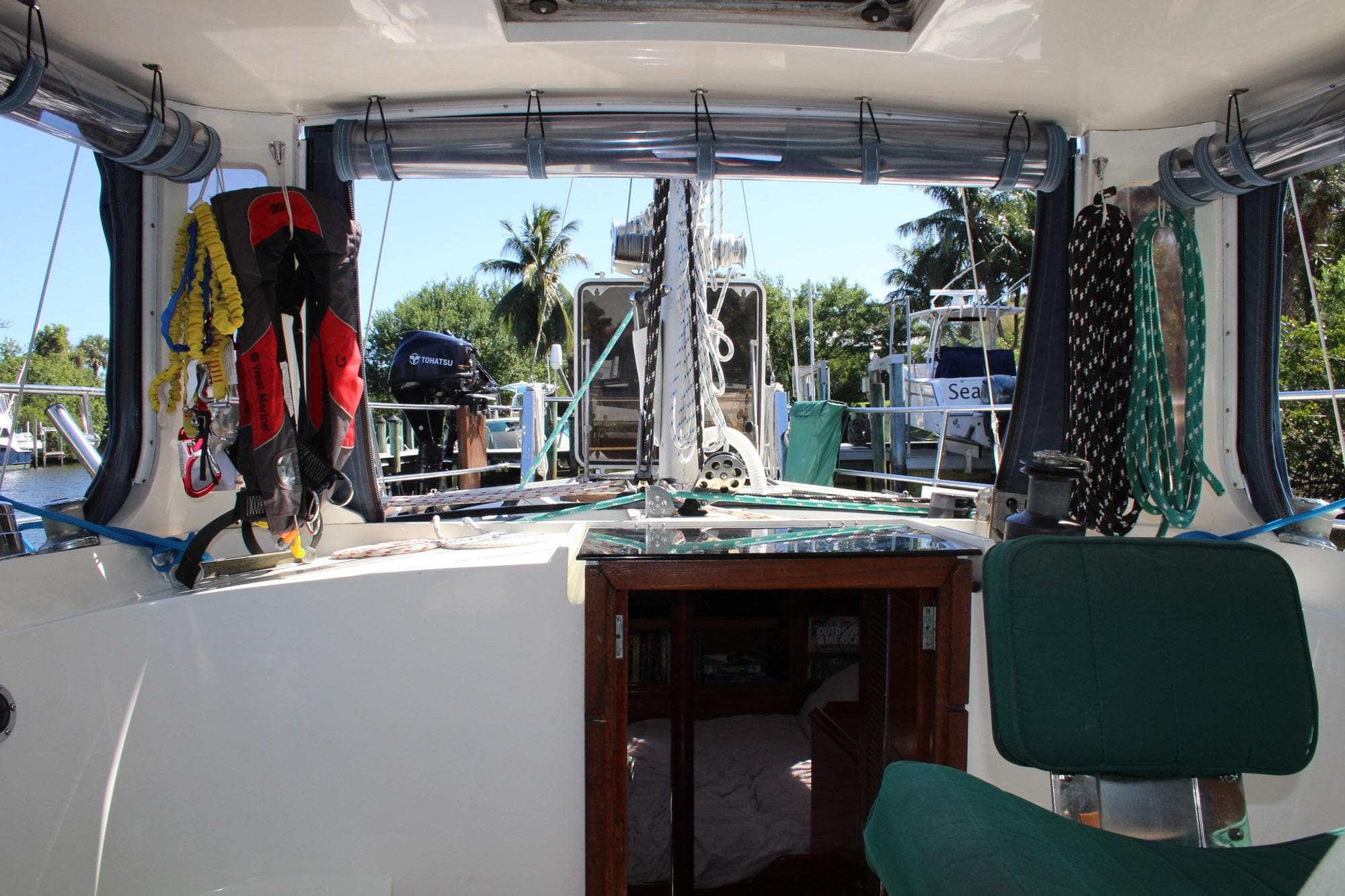 1974 Camper & Nicholsons Center Cockpit interior with nautical equipment and marina view.