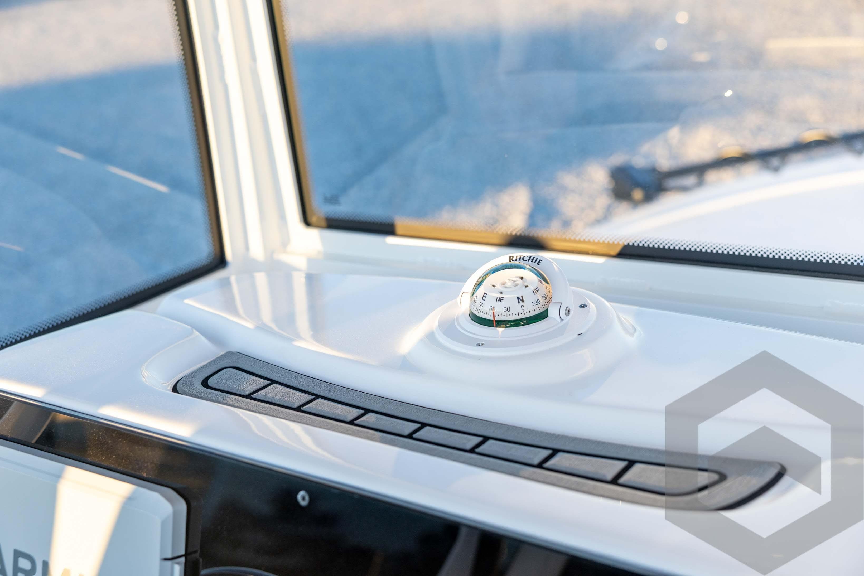 Compass on 2026 Tidewater 2110 Bay Max boat dashboard, close-up view.
