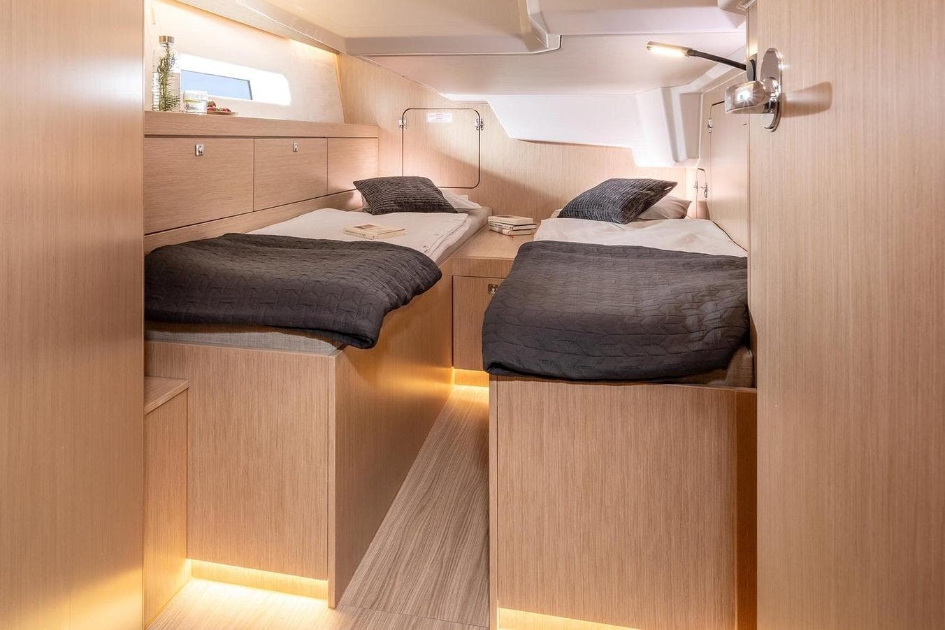 Luxurious interior cabin of 2026 Bavaria C46 yacht with twin beds and modern lighting.