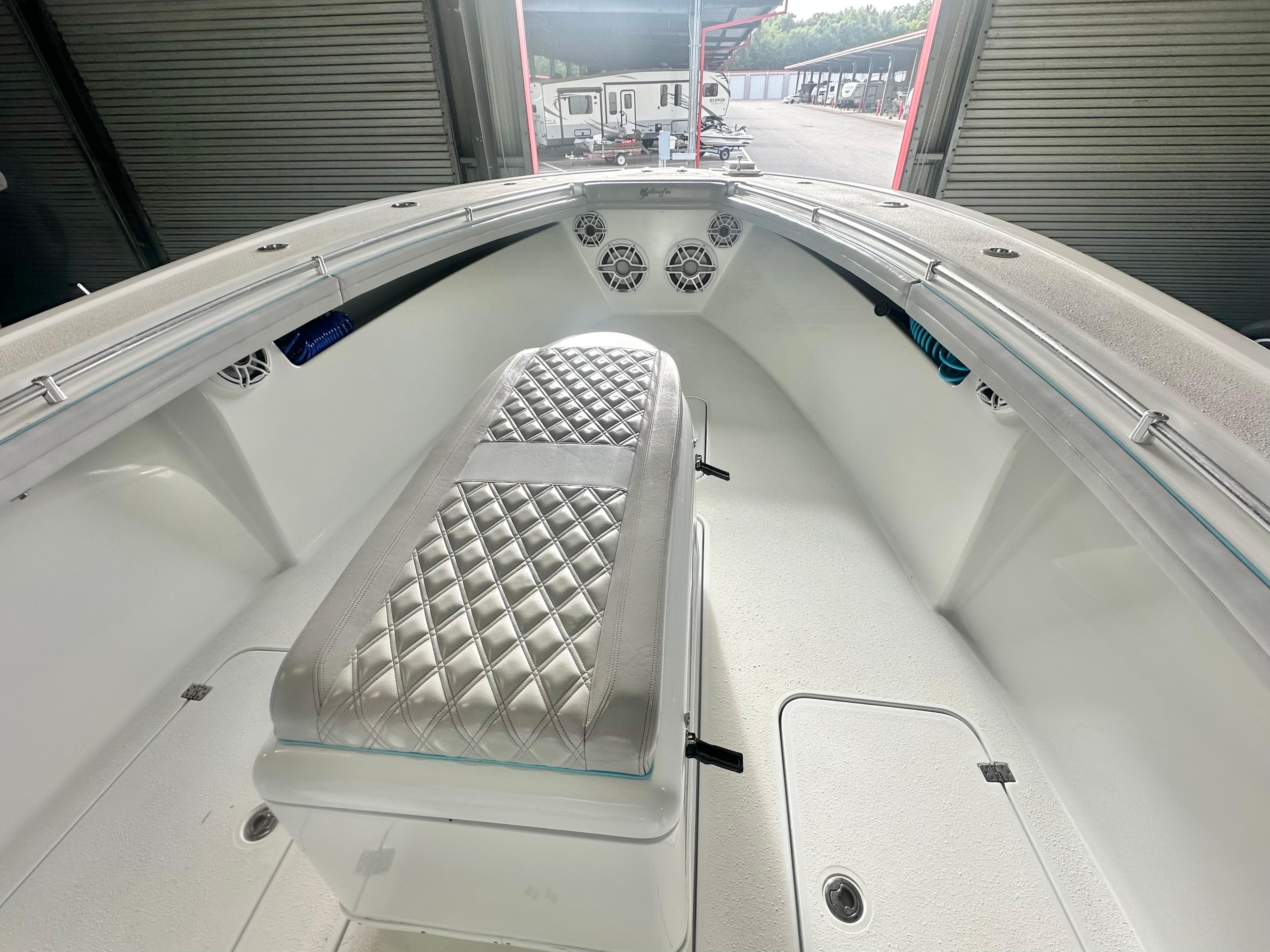 2021 Yellowfin 36 Offshore boat interior with diamond-stitched seating and storage compartments.