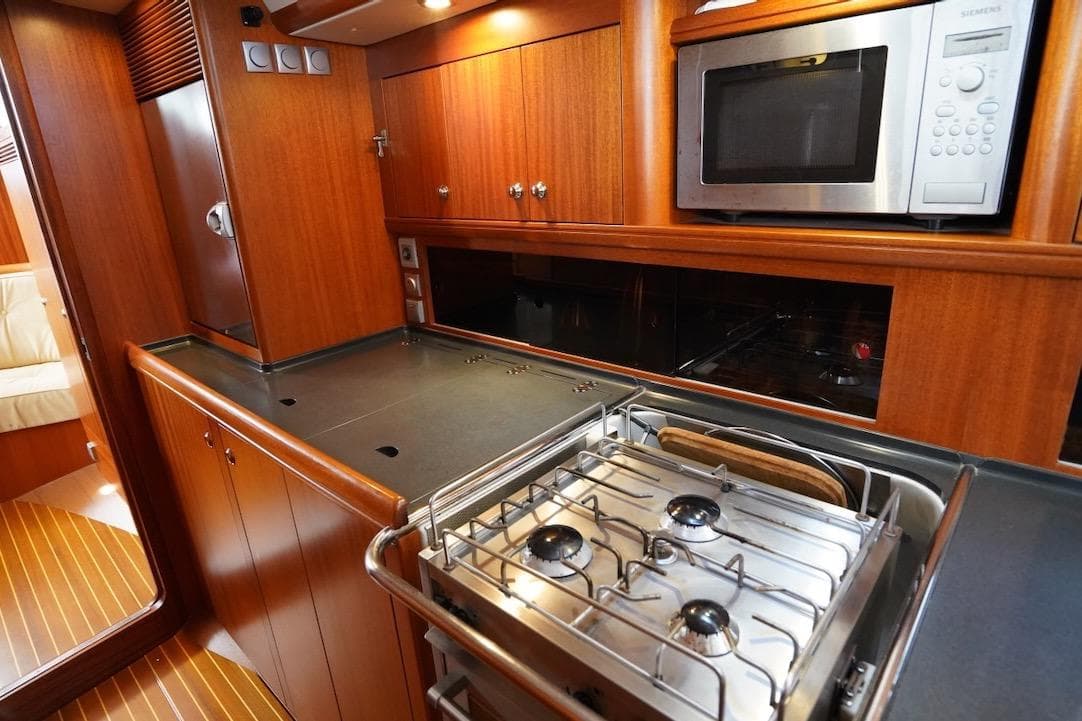 Luxurious Najad 511 yacht kitchen interior with stove and microwave, 2010 model.