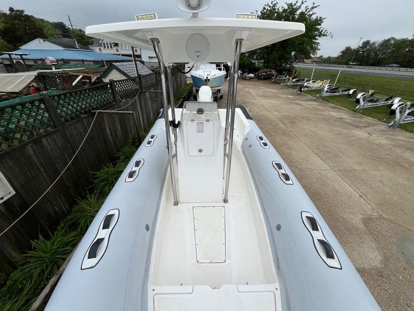 Apex A-24 boat, 2019 model, docked in a marina with overcast skies.