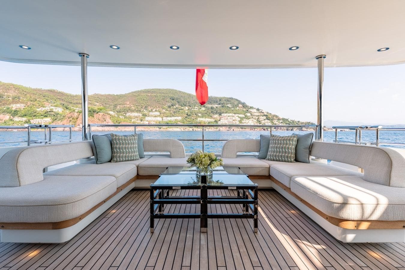 Luxurious 2020 Moonen Martinique YN1 yacht deck with elegant seating and scenic ocean view.