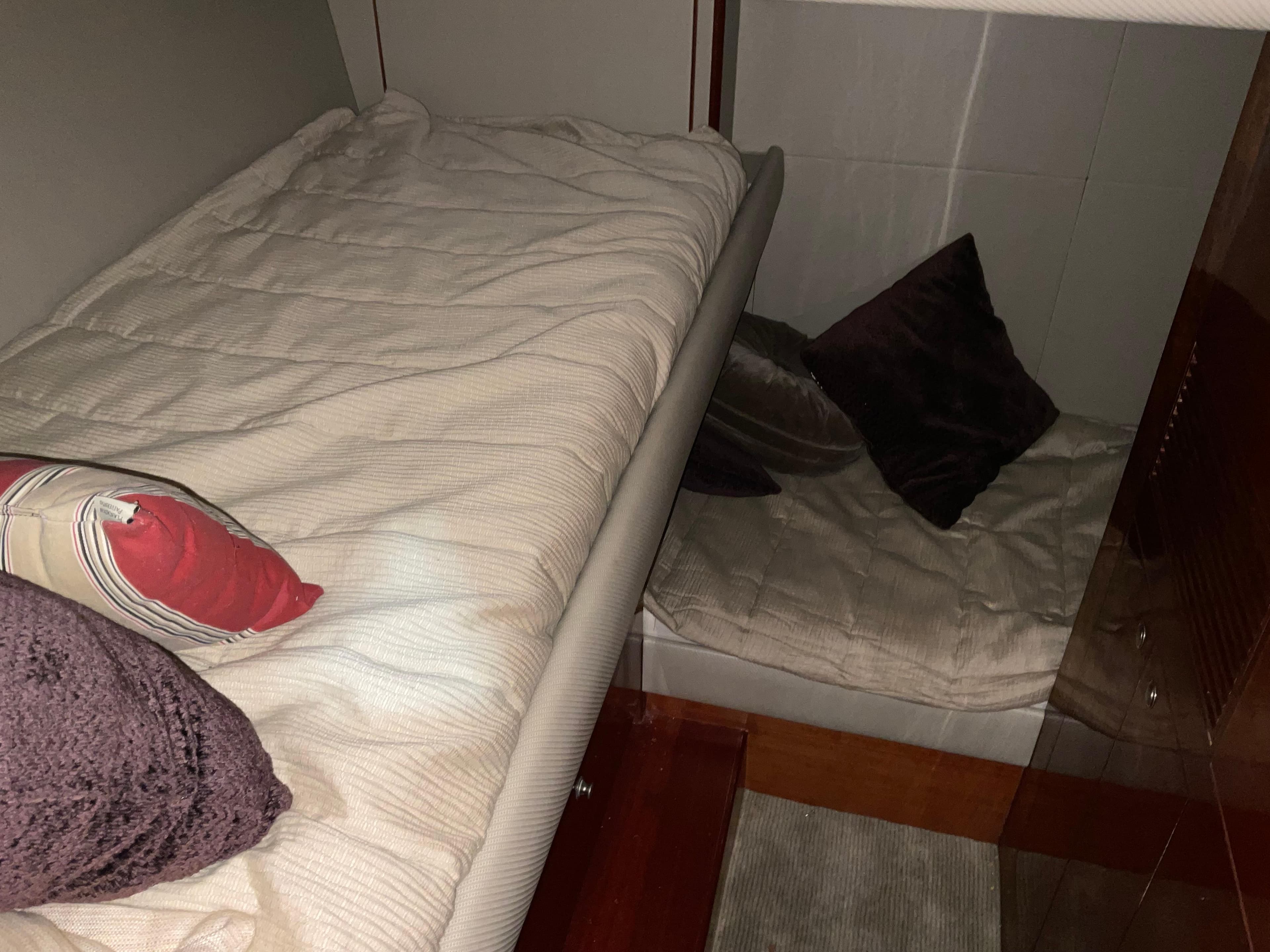 Cozy cabin interior of 2007 Ocean Alexander 54V yacht with comfortable bedding and pillows.