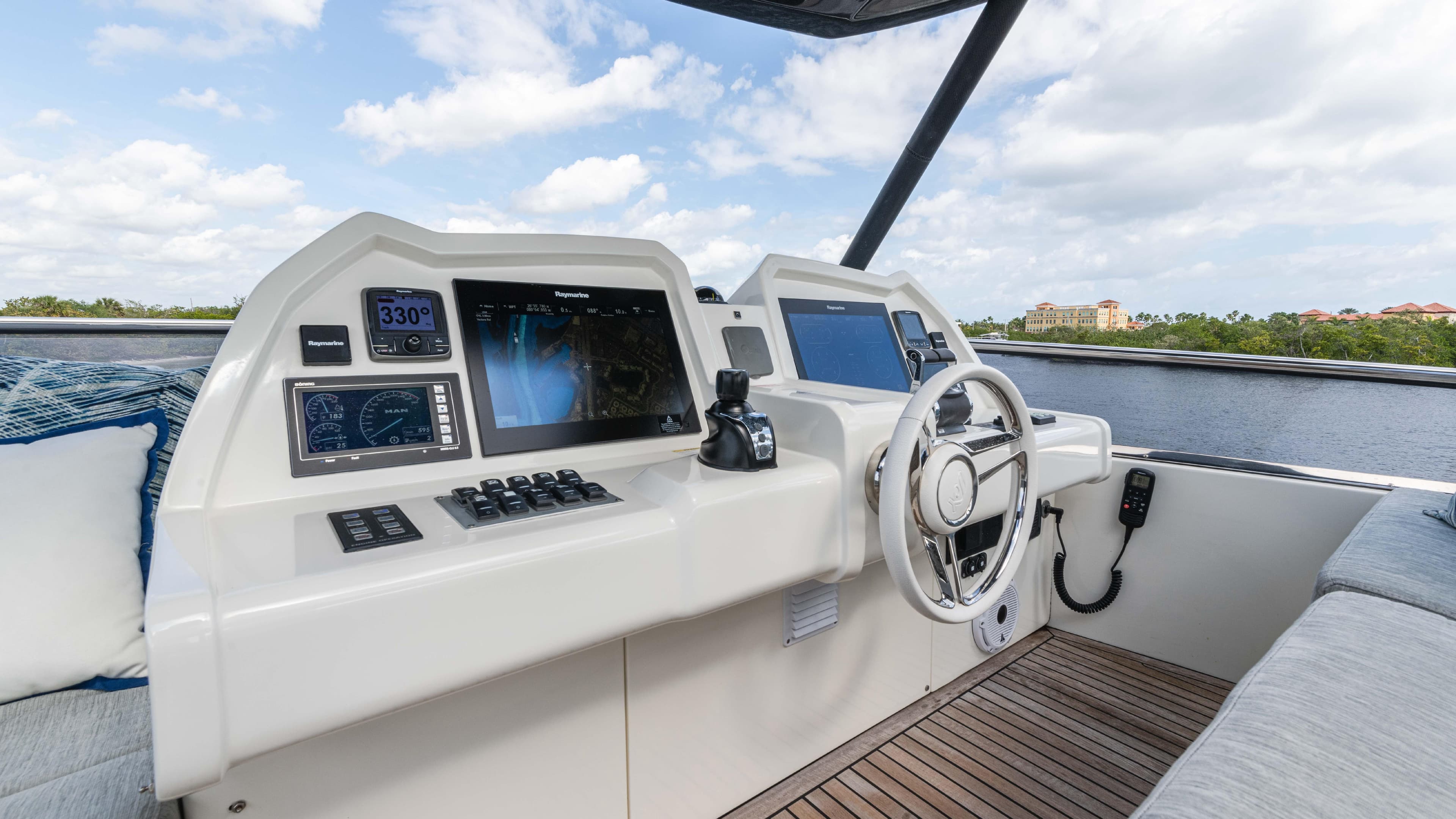 2016 Monte Carlo Yachts MCY 65 helm with modern navigation equipment and scenic water view.