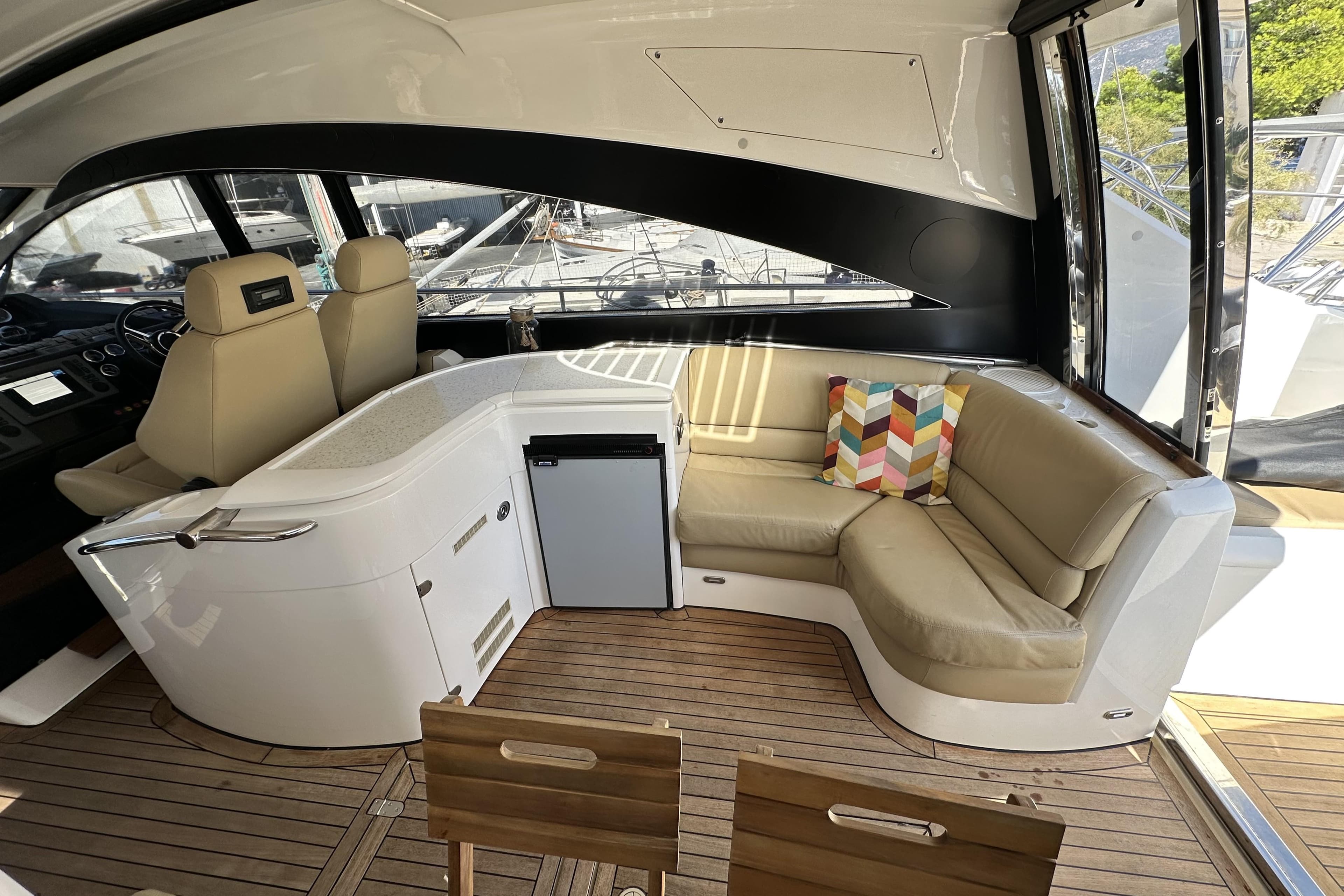 Luxurious interior of 2004 Fairline Targa 62 yacht with seating and mini fridge.