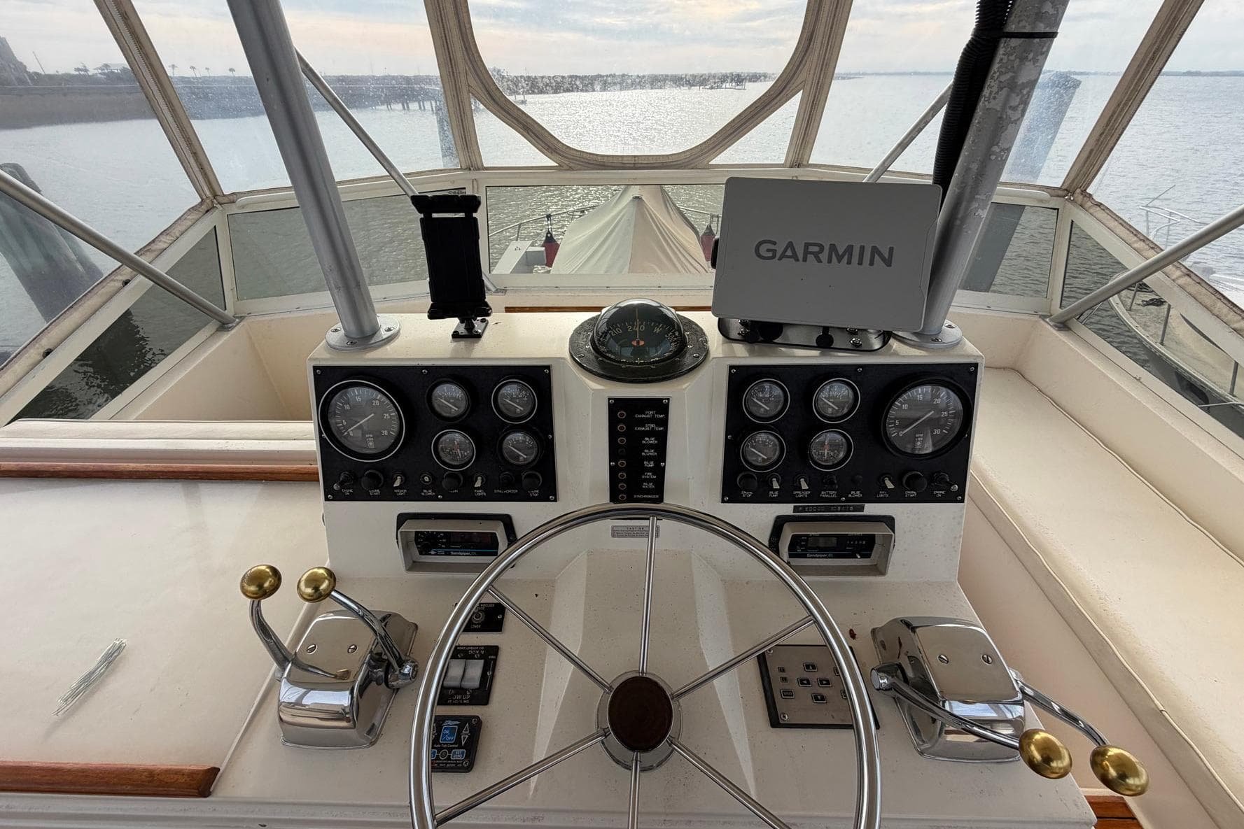 1987 Viking 44 Motor Yacht helm with Garmin navigation, steering wheel, and control panels.