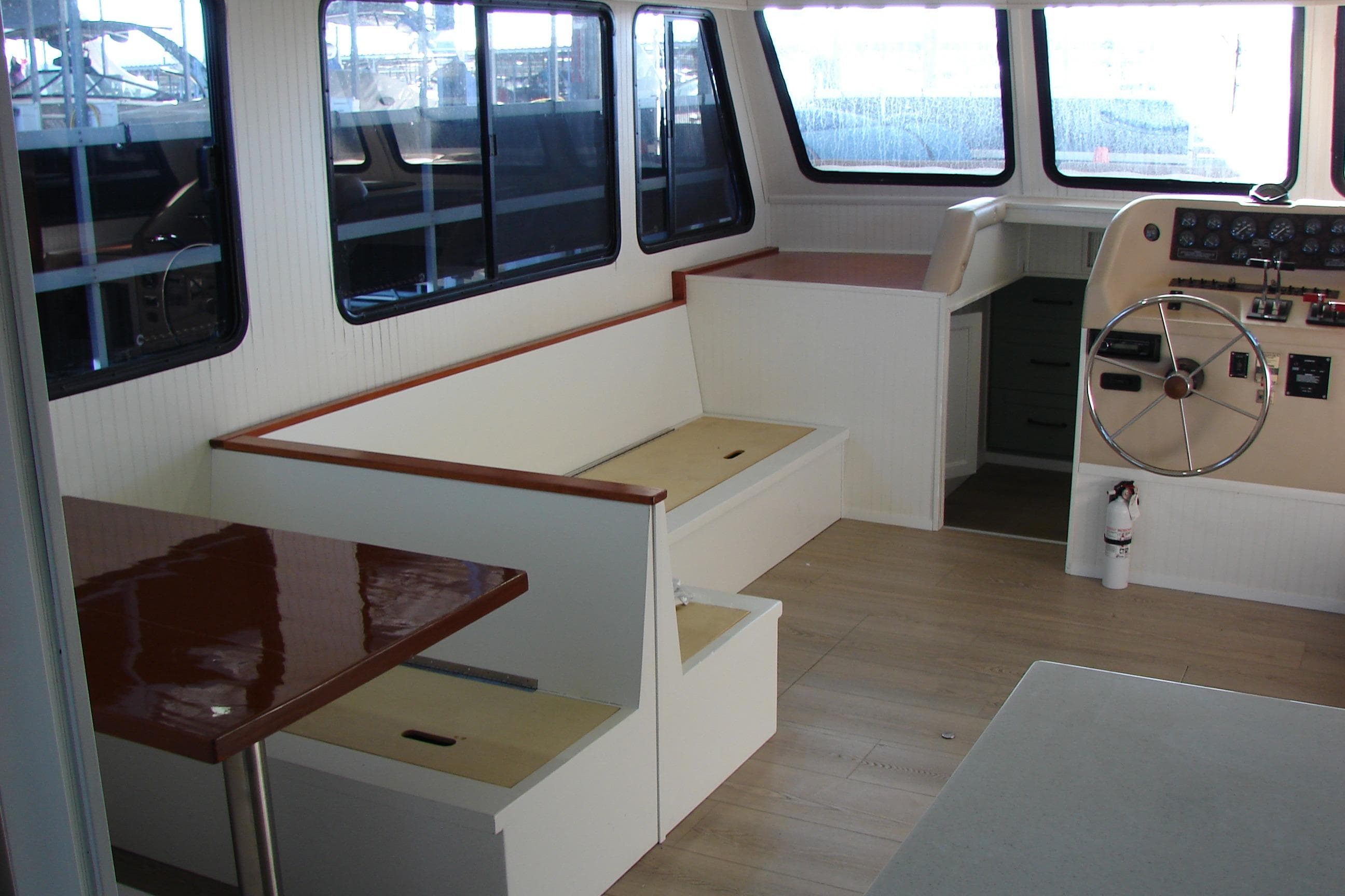 Interior of a 1997 Gibson 47 Sport Houseboat with seating and helm.