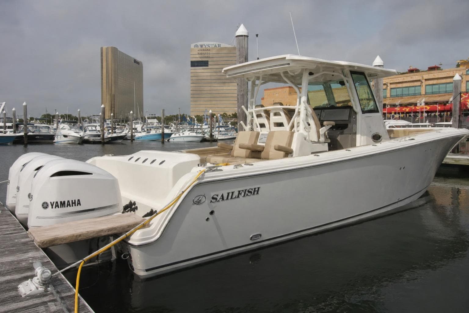 2019 Sailfish 360 CC boat docked with Yamaha engines in a marina setting.