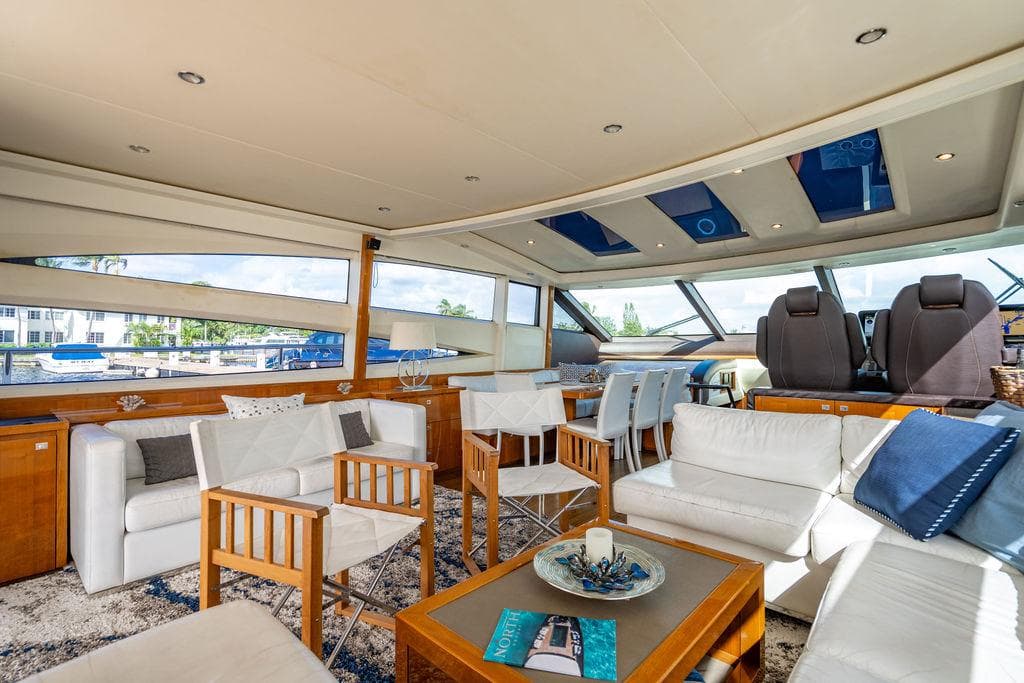 Luxurious interior of 2010 Princess V78 yacht with elegant seating and panoramic windows.