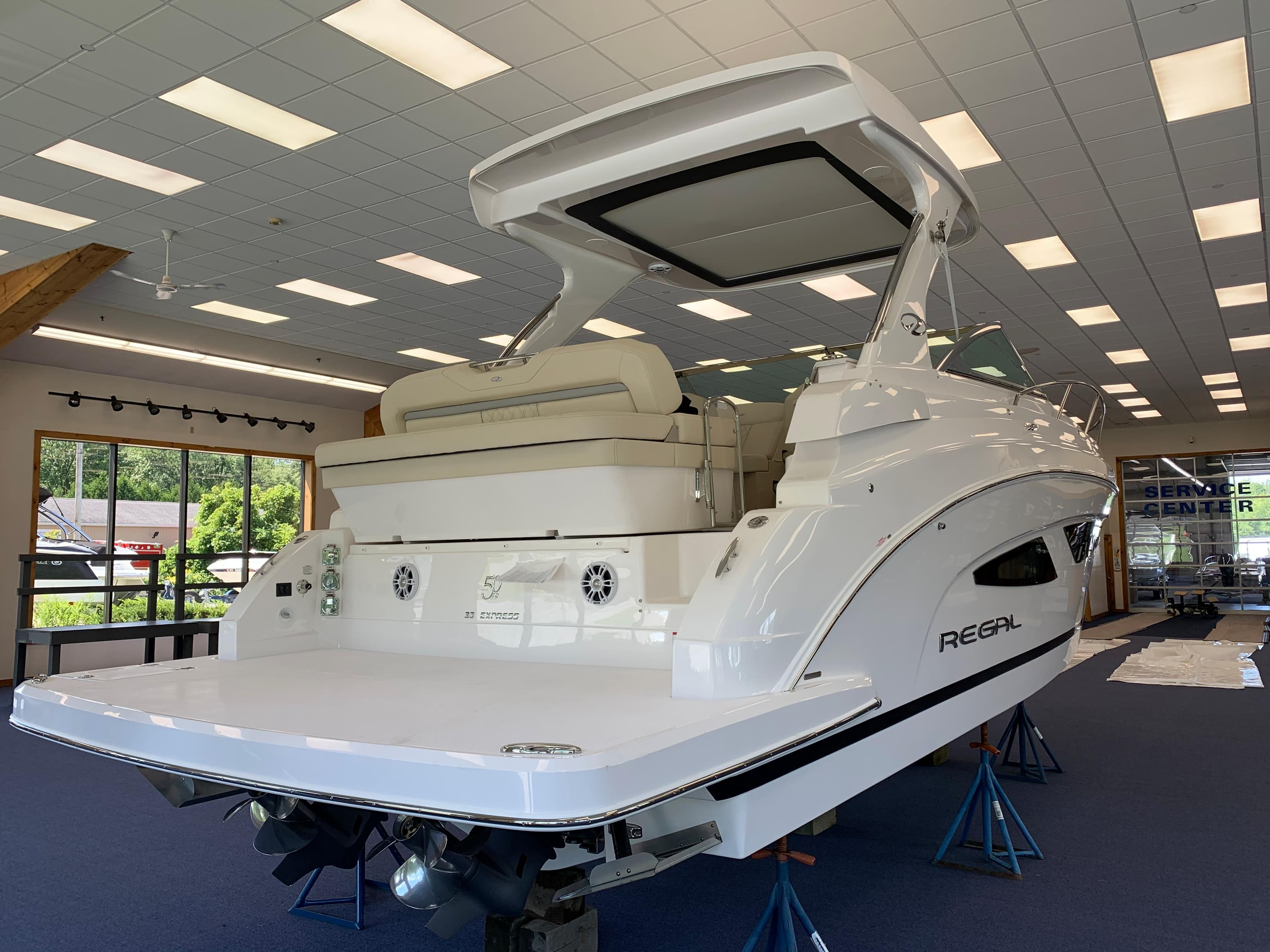 2021 Regal 33 Express boat displayed indoors on stands.