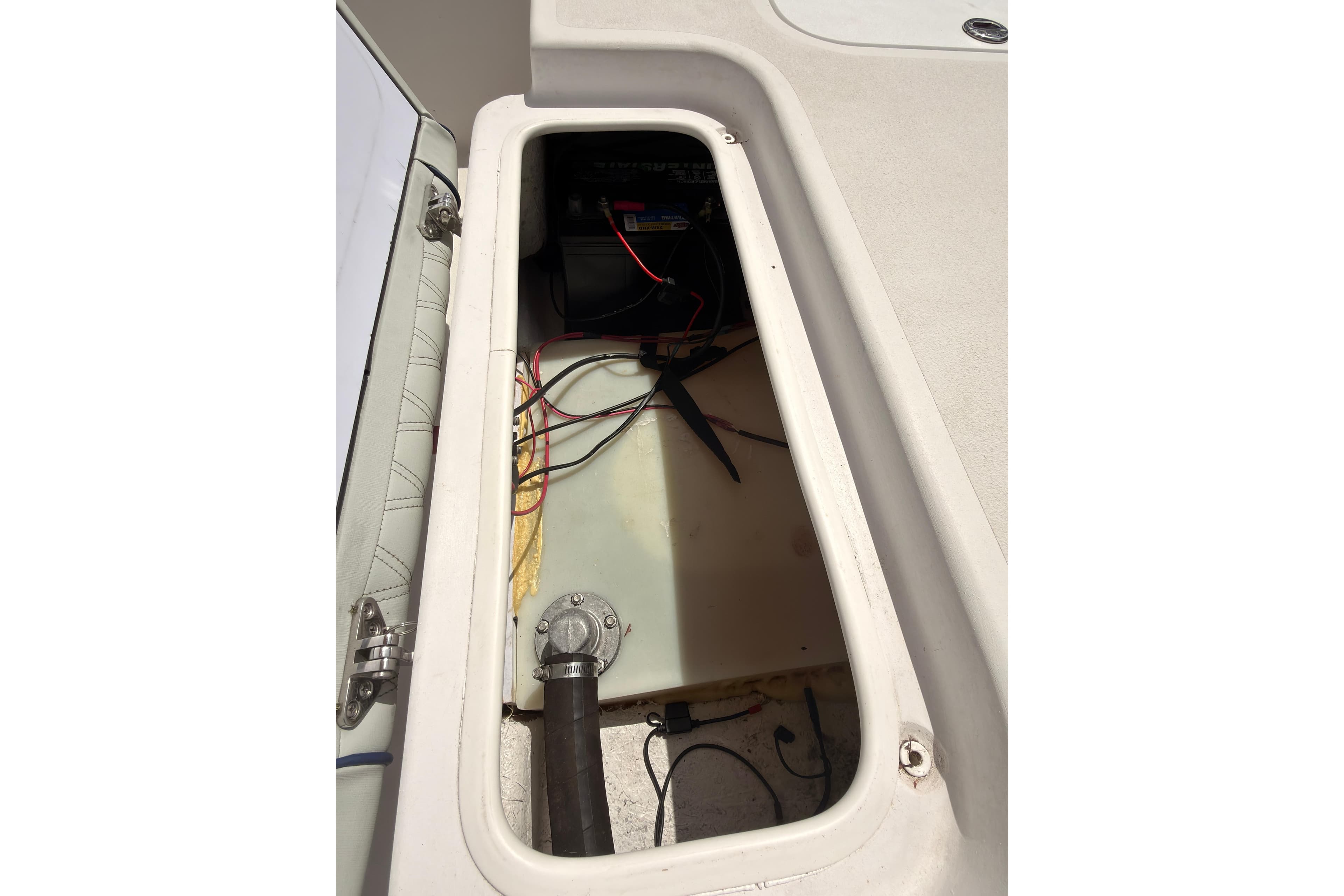 Open compartment of ALK2 HS 17 boat, showing wiring and battery setup.