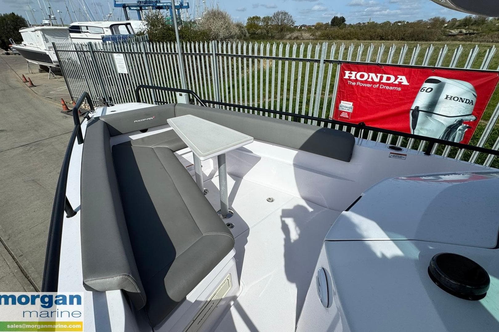 2021 Axopar 28 Cabin boat with seating area and table, displayed at Morgan Marine.
