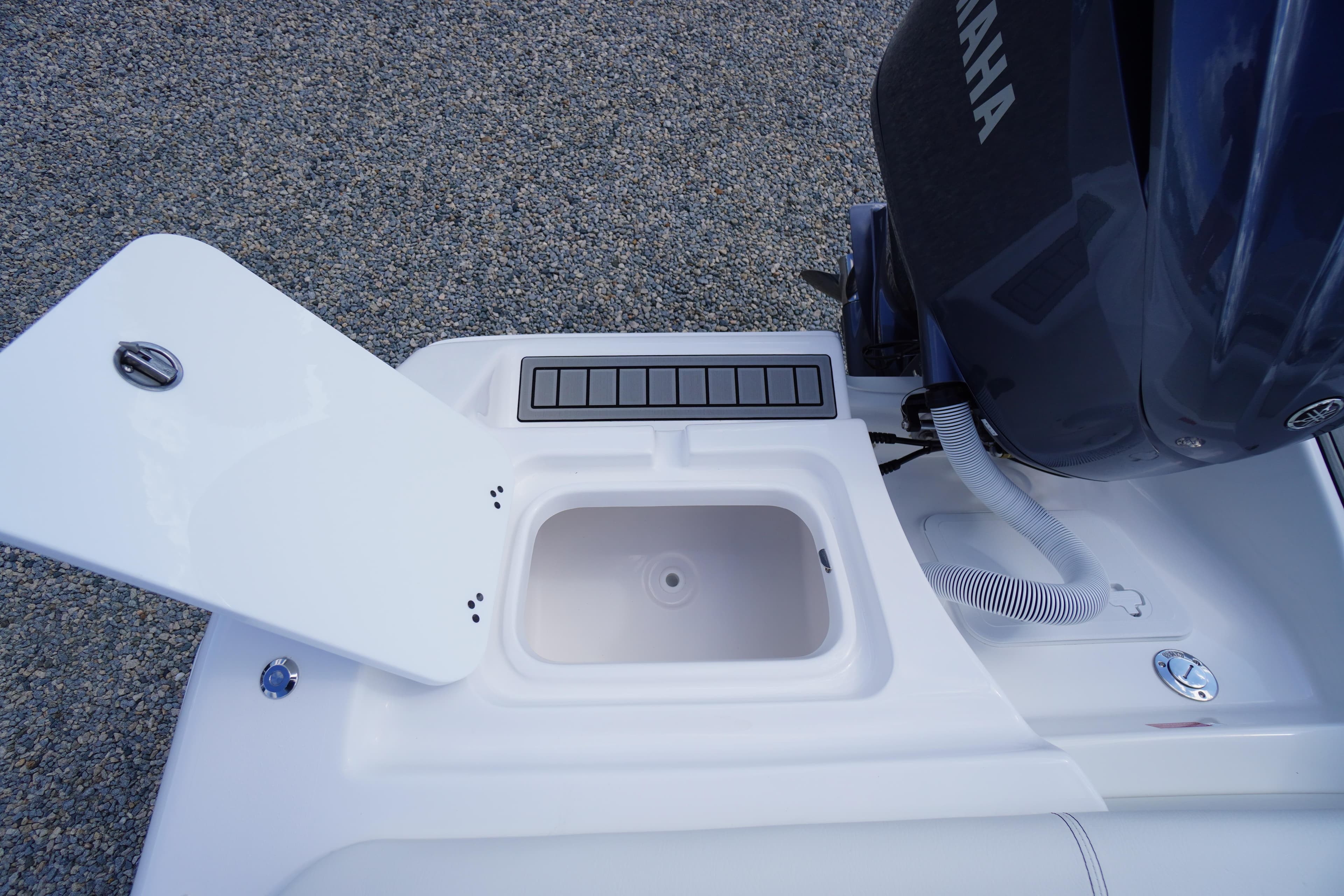 2026 Tidewater 220 LXF boat with Yamaha engine and open storage compartment.