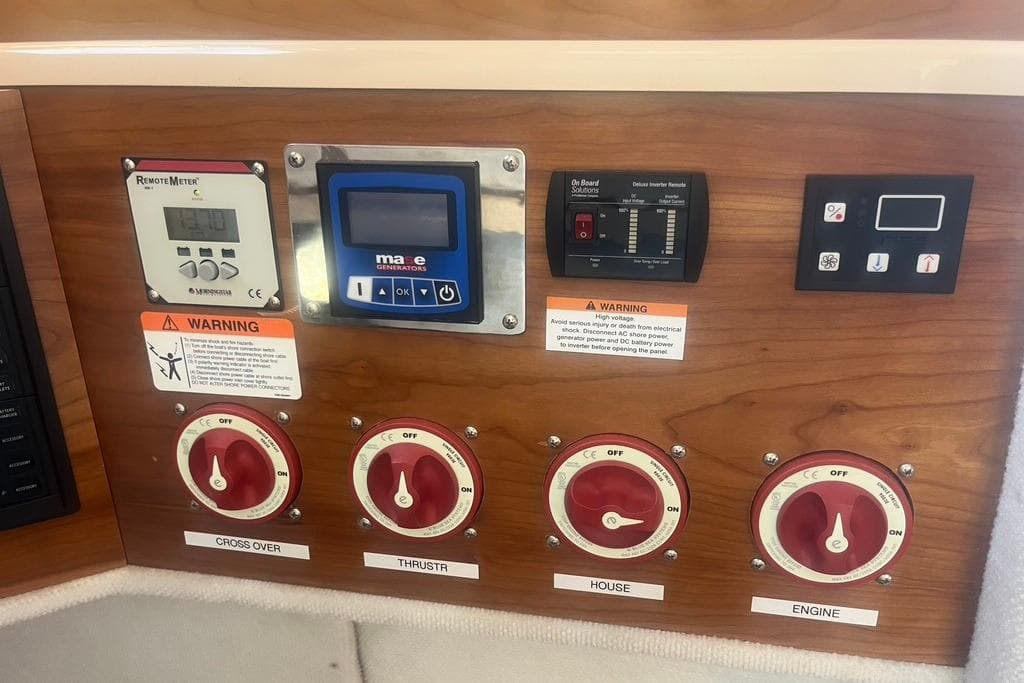 Control panel of a 2013 Cutwater C-28 boat with various switches and meters.