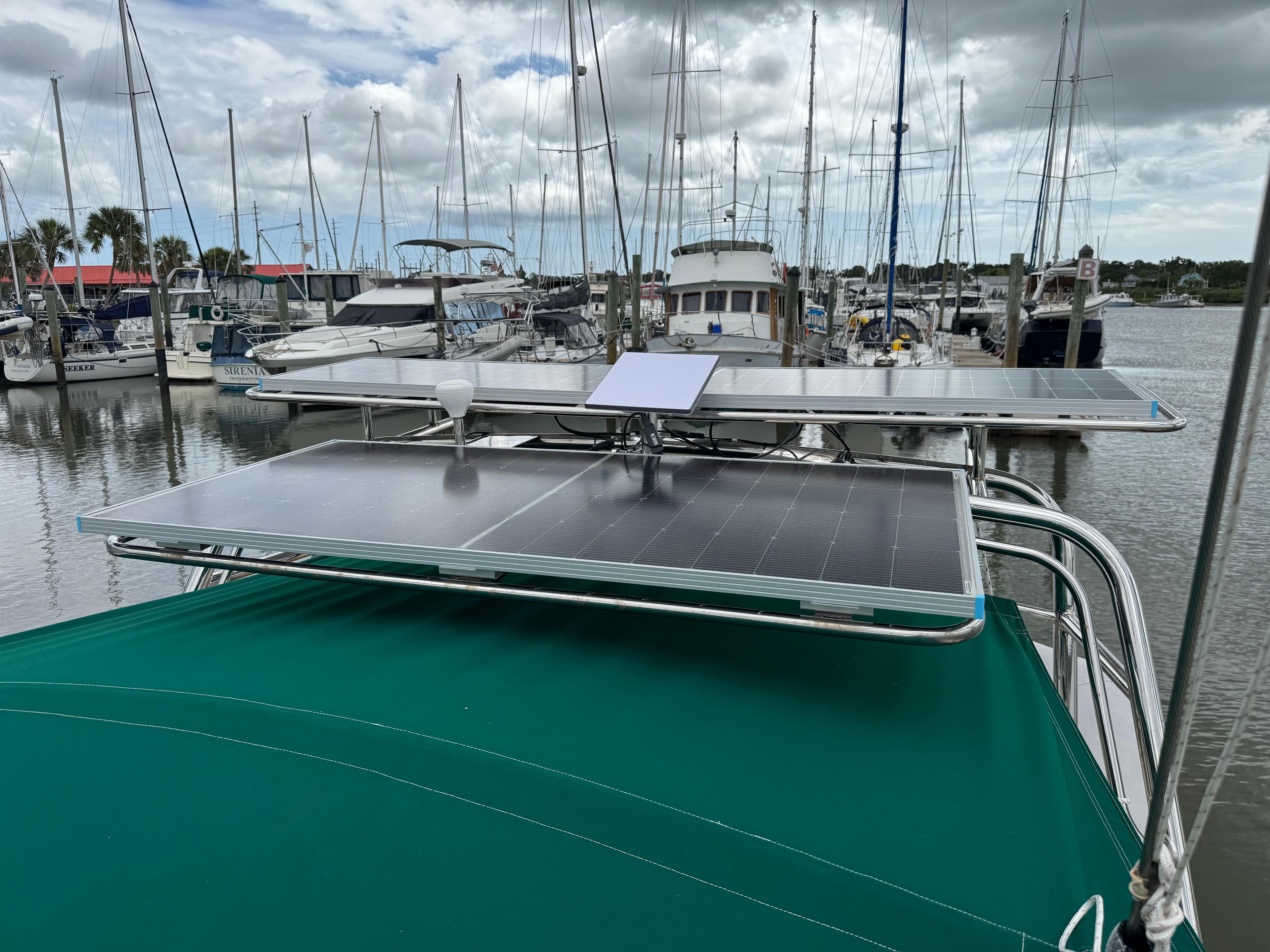 Beneteau Oceanis 461 sailboat with solar panels docked at a marina, 1997 model.