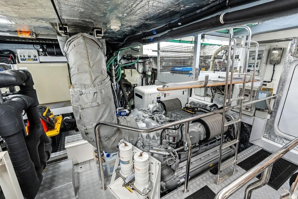Engine room of a 2012 Sunseeker 88 Yacht, showcasing mechanical components and equipment.