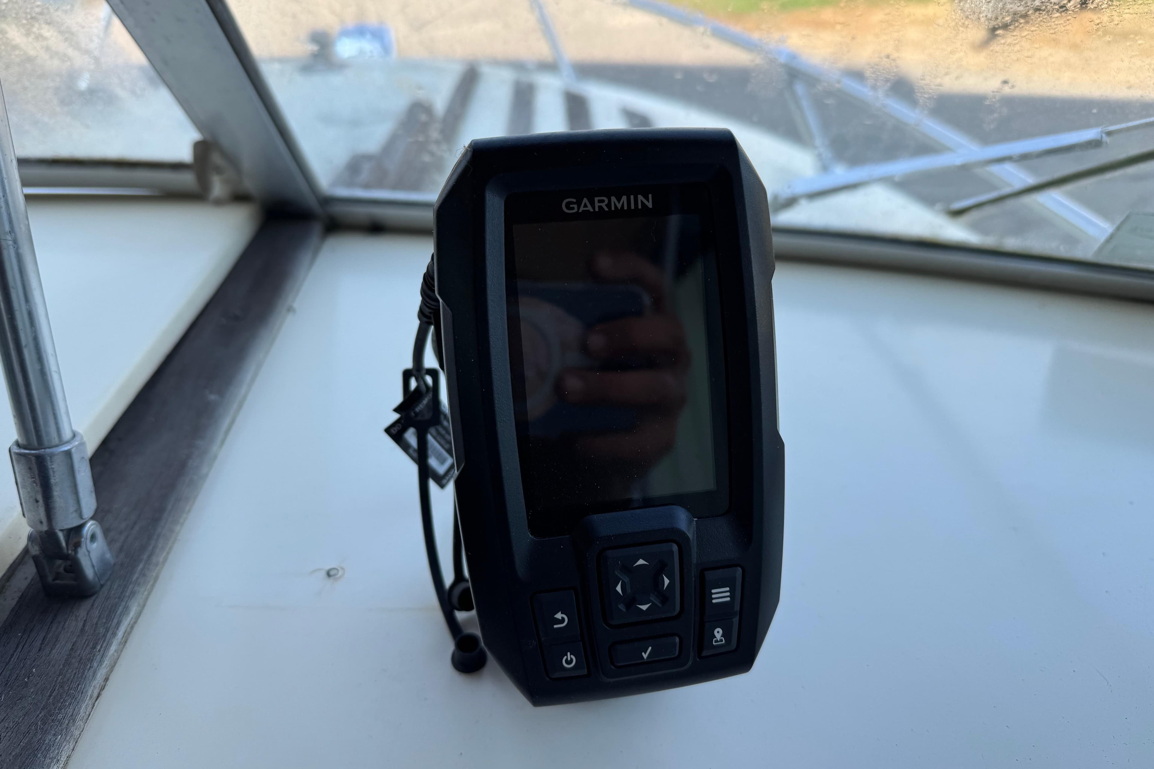 Garmin device on 1975 Century Raven boat dashboard, with window view.