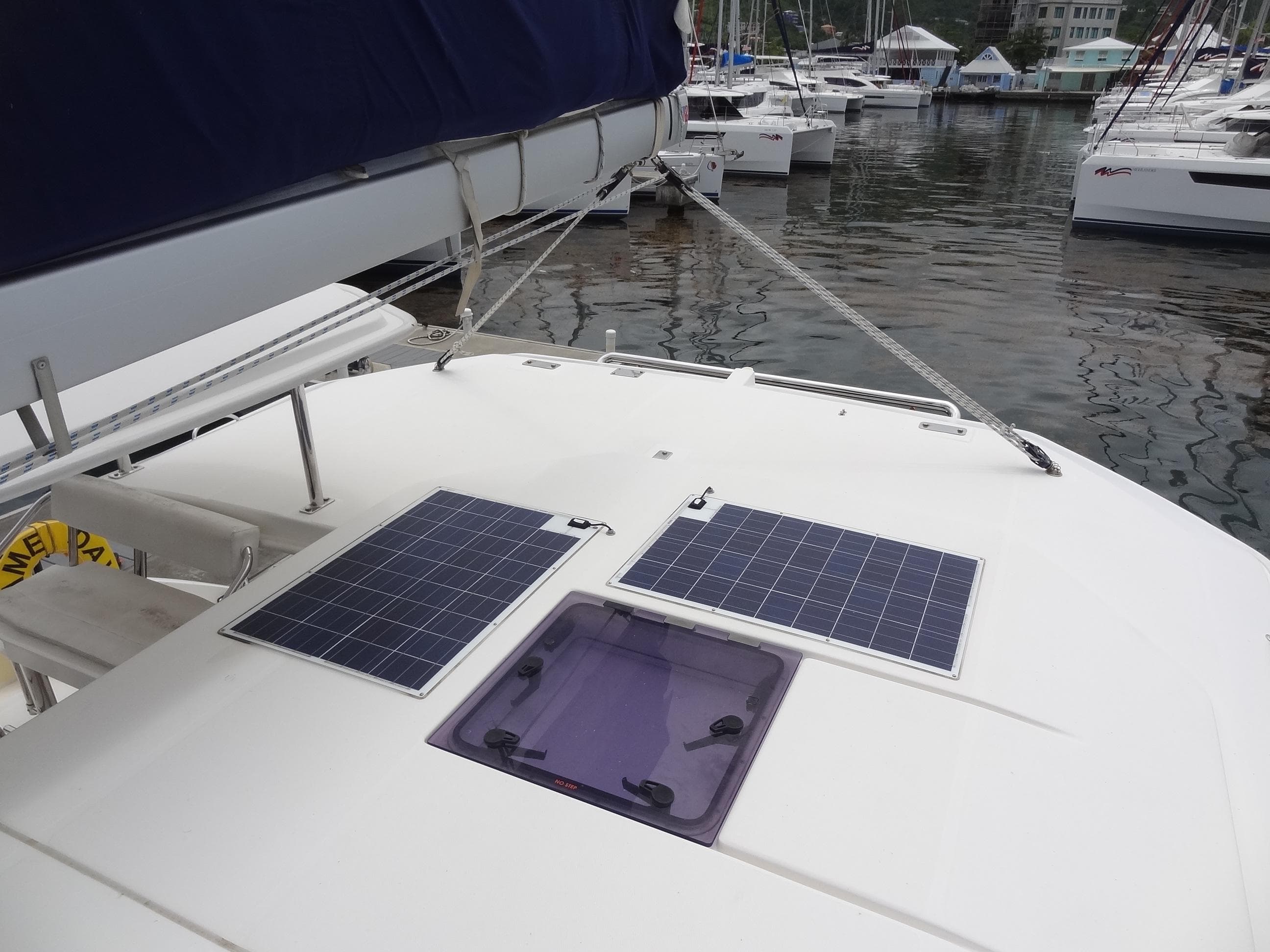 Leopard 40 2020 catamaran with solar panels docked in a marina.