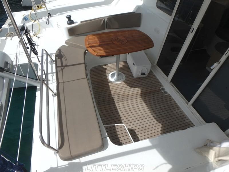 Deck area of 2015 Fountaine Pajot MAHE EVO with table and bench seating.
