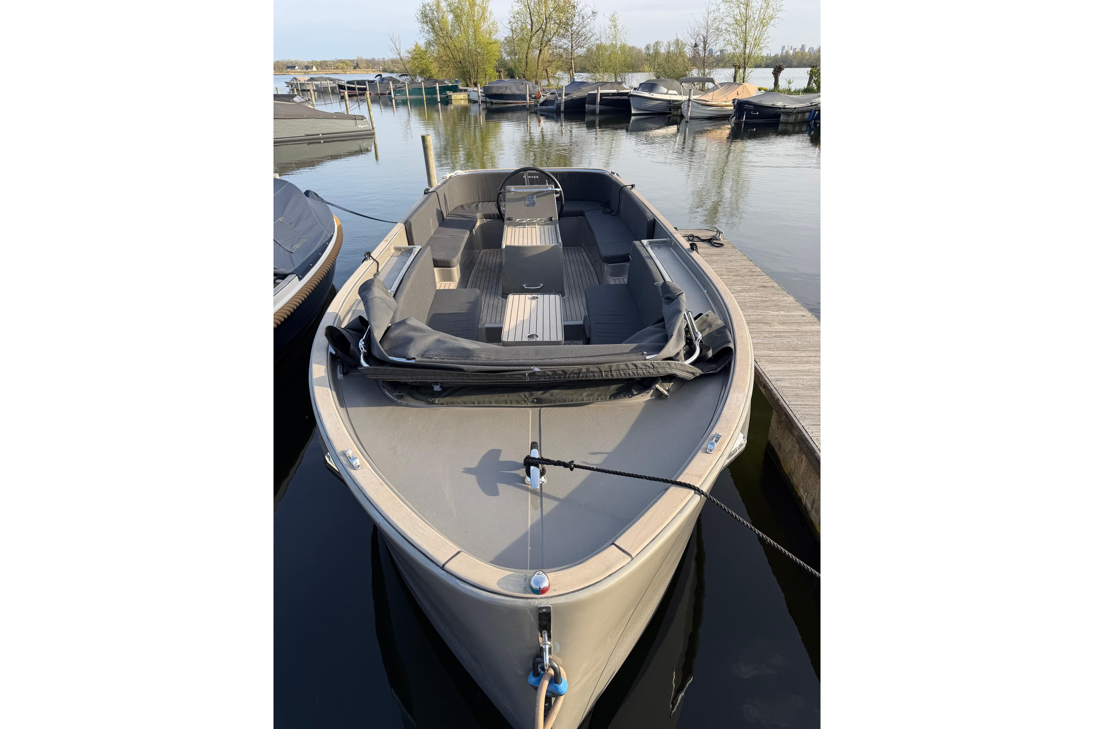 2019 Seafury Hawker 725 boat docked at a marina, calm water background.
