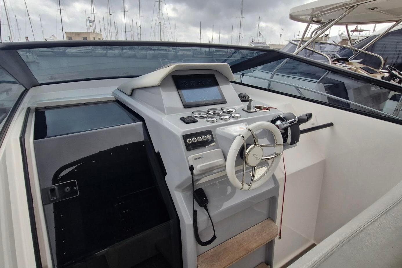 2022 RIO 34 Daytona boat helm with modern controls and steering wheel.