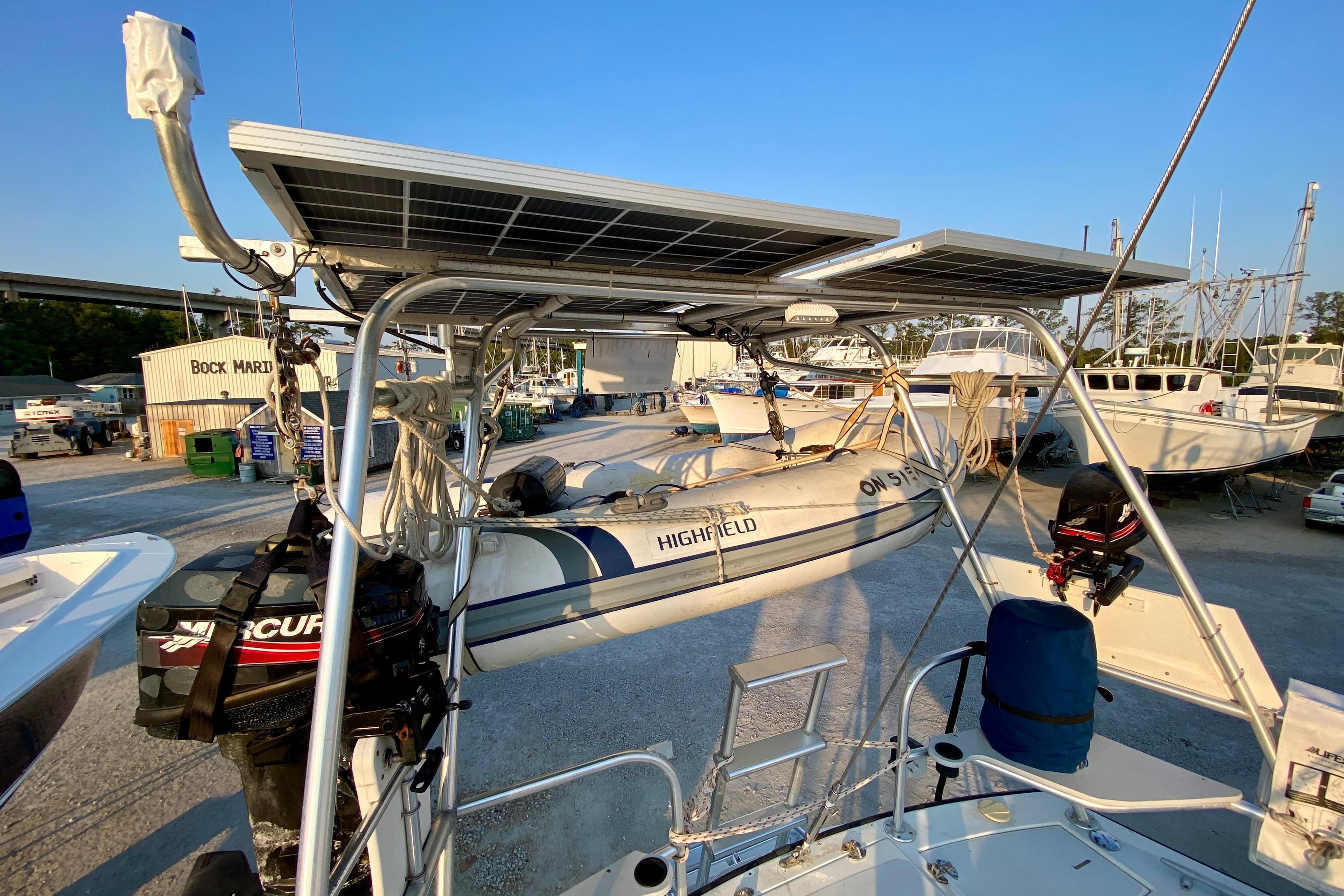 1986 Gulfstar Hirsch 45 sailboat with solar panels and dinghy at dockyard.