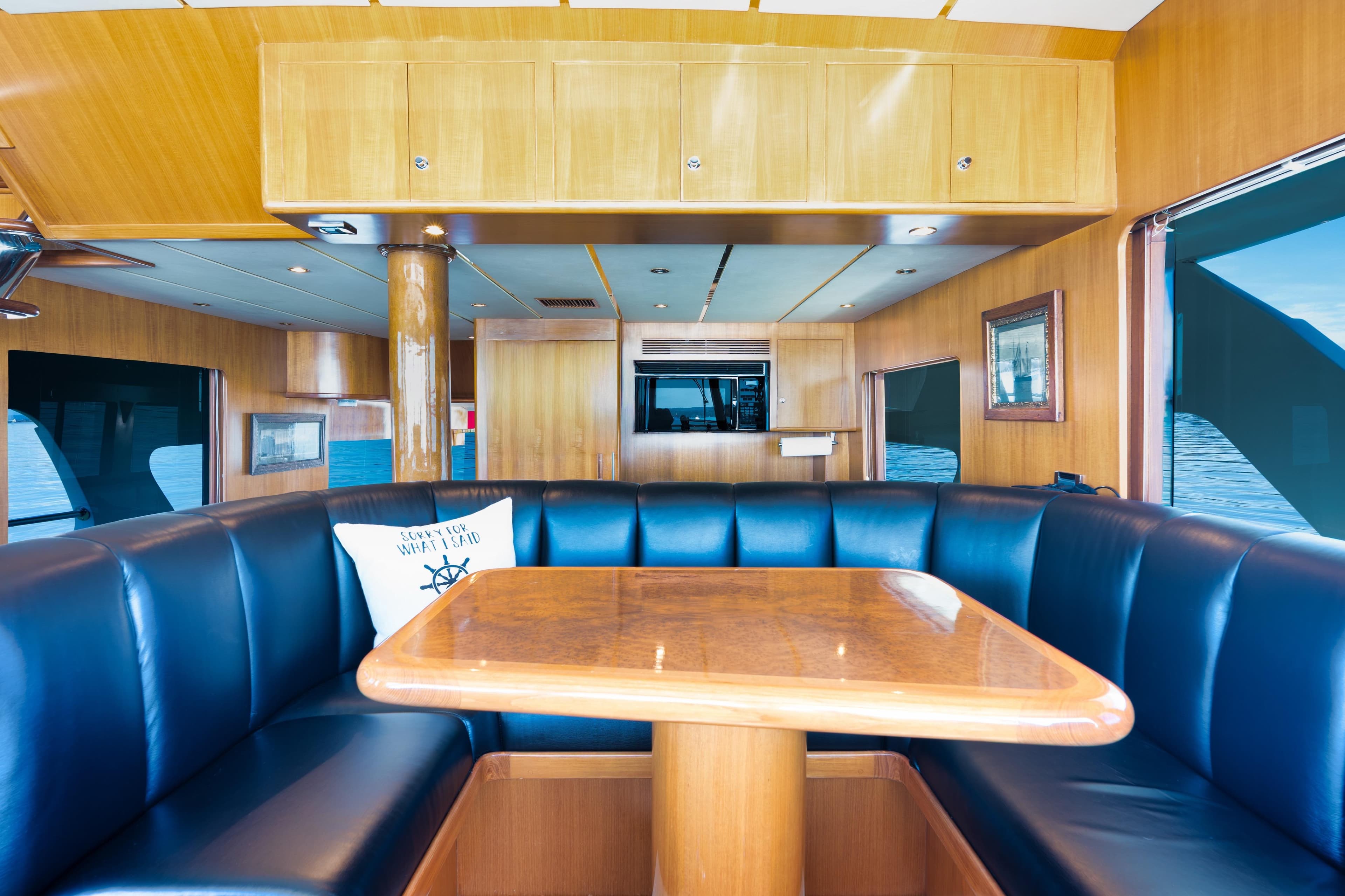 Luxurious interior of 2003 Ocean Alexander 700 Classicco yacht with elegant wood and leather seating.
