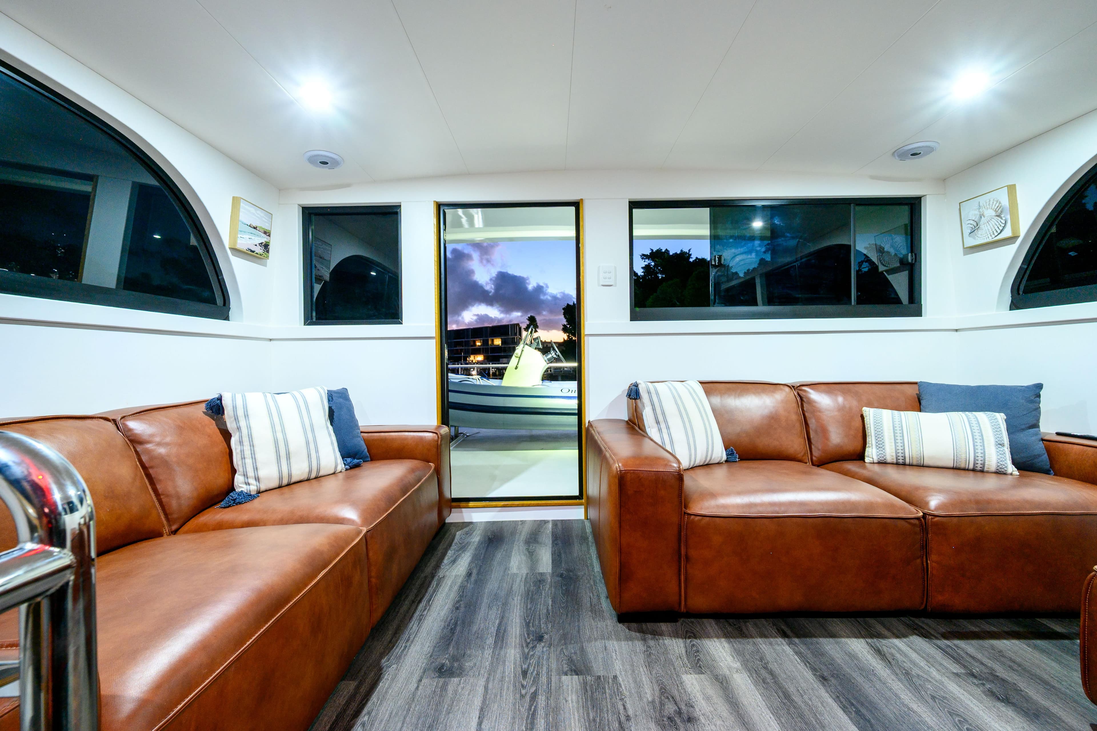 Luxurious Coral Coast 62 yacht interior, featuring leather sofas and modern decor, 2019 model.