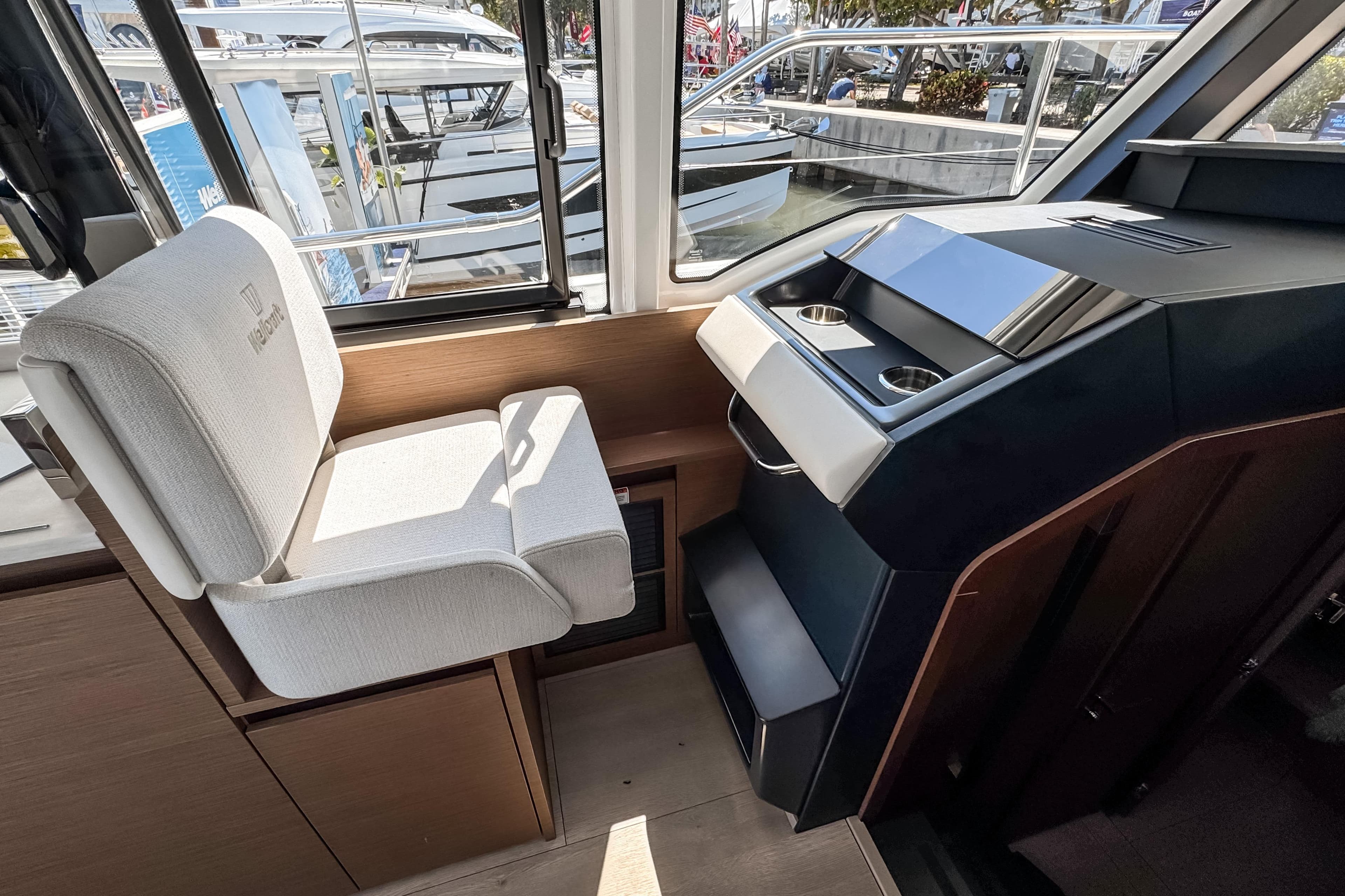 Interior of Wellcraft 44 Explorer 2026 with helm and seating.