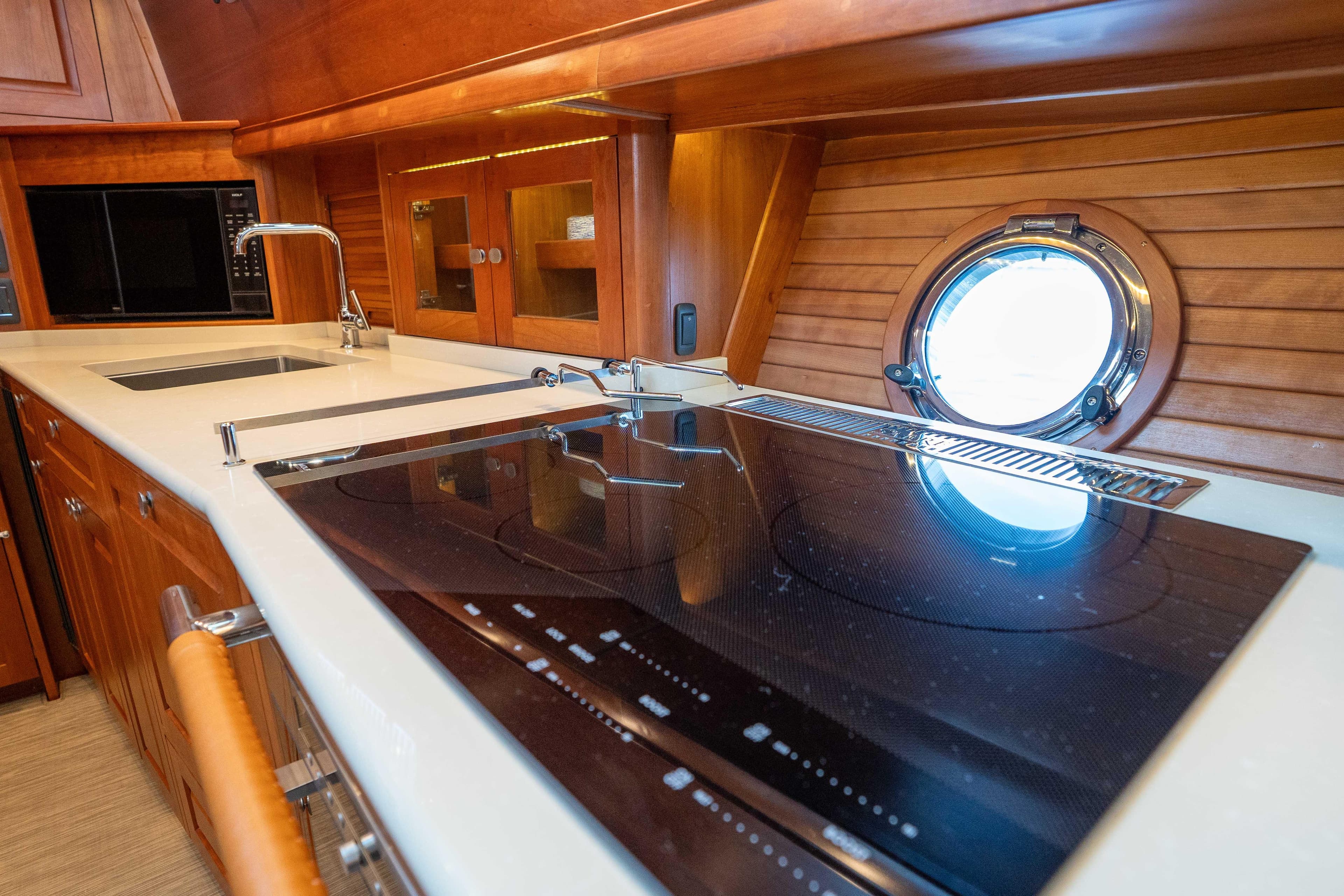Luxurious galley kitchen in 2018 Sabre 66 Dirigo yacht with modern appliances and porthole.
